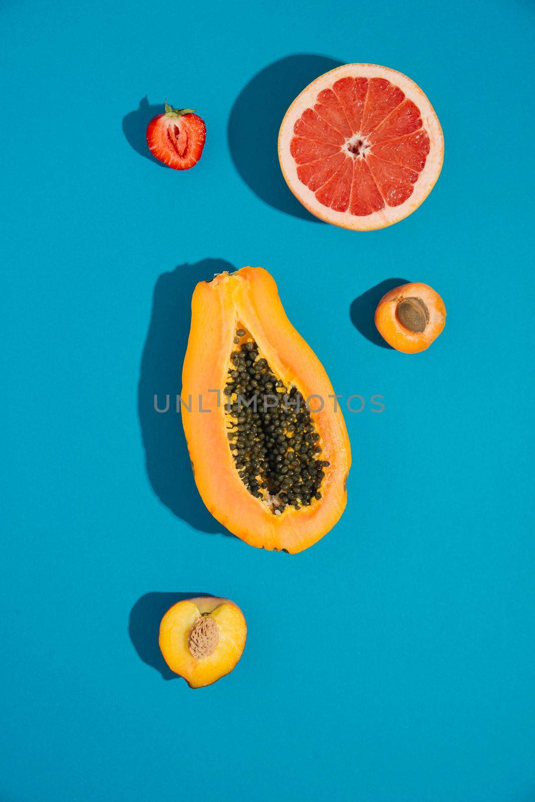 tropical summer fruits on blue background by maramorosz