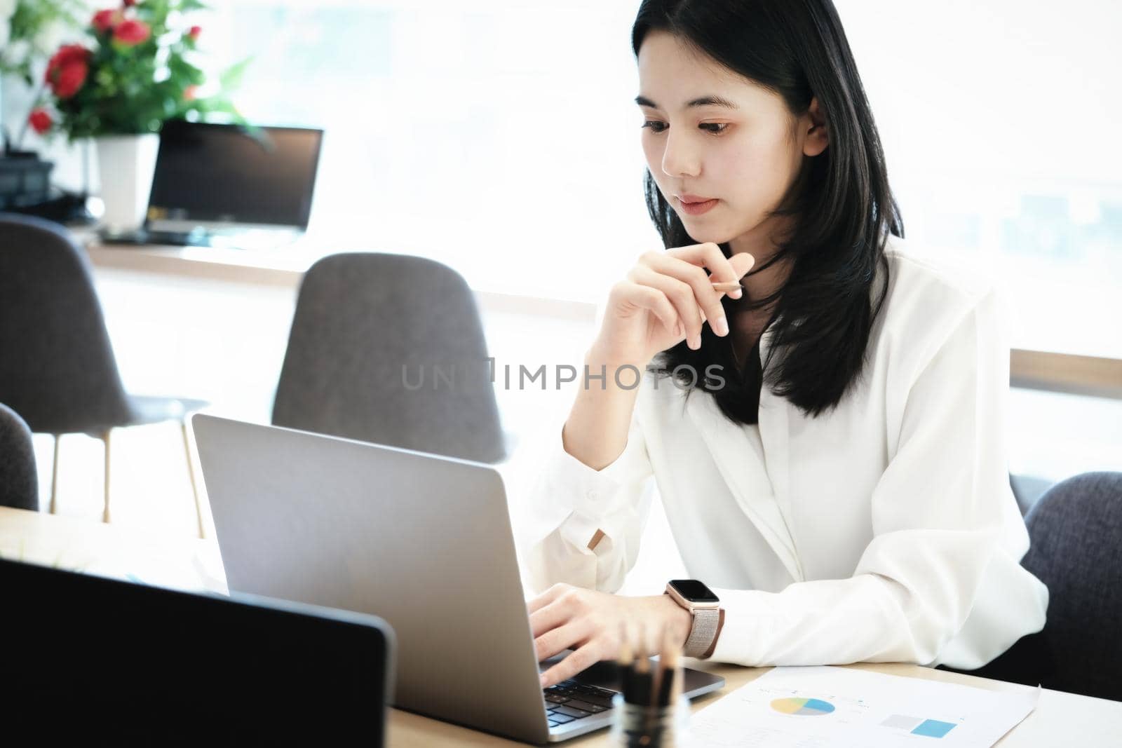 Female employees are working at home through computers to maintain social distancing to reduce the spread of coronavirus