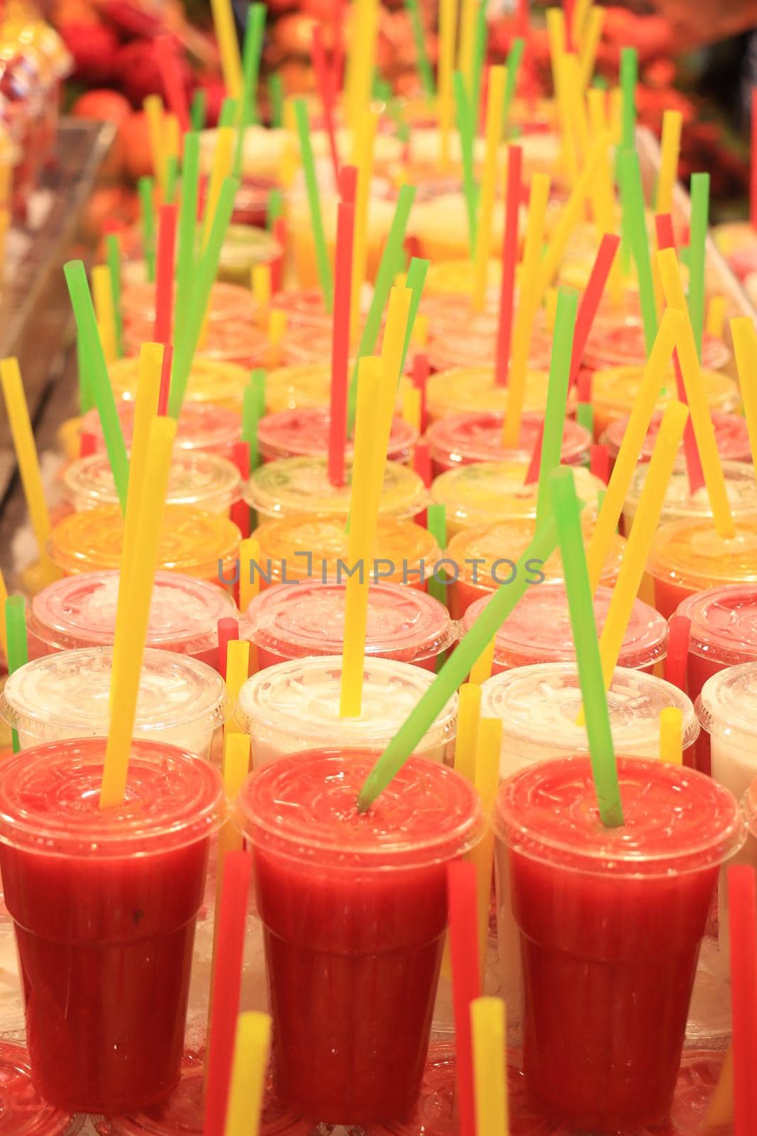 Fresh made fruity smoothies on ice at a market in Barcelona