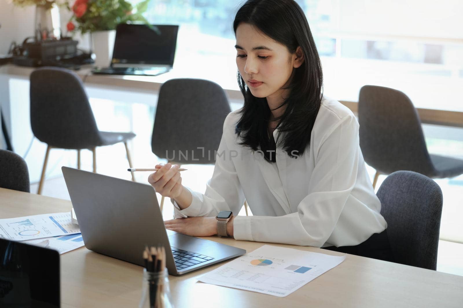 Female employees are working at home through computers to maintain social distancing to reduce the spread of coronavirus