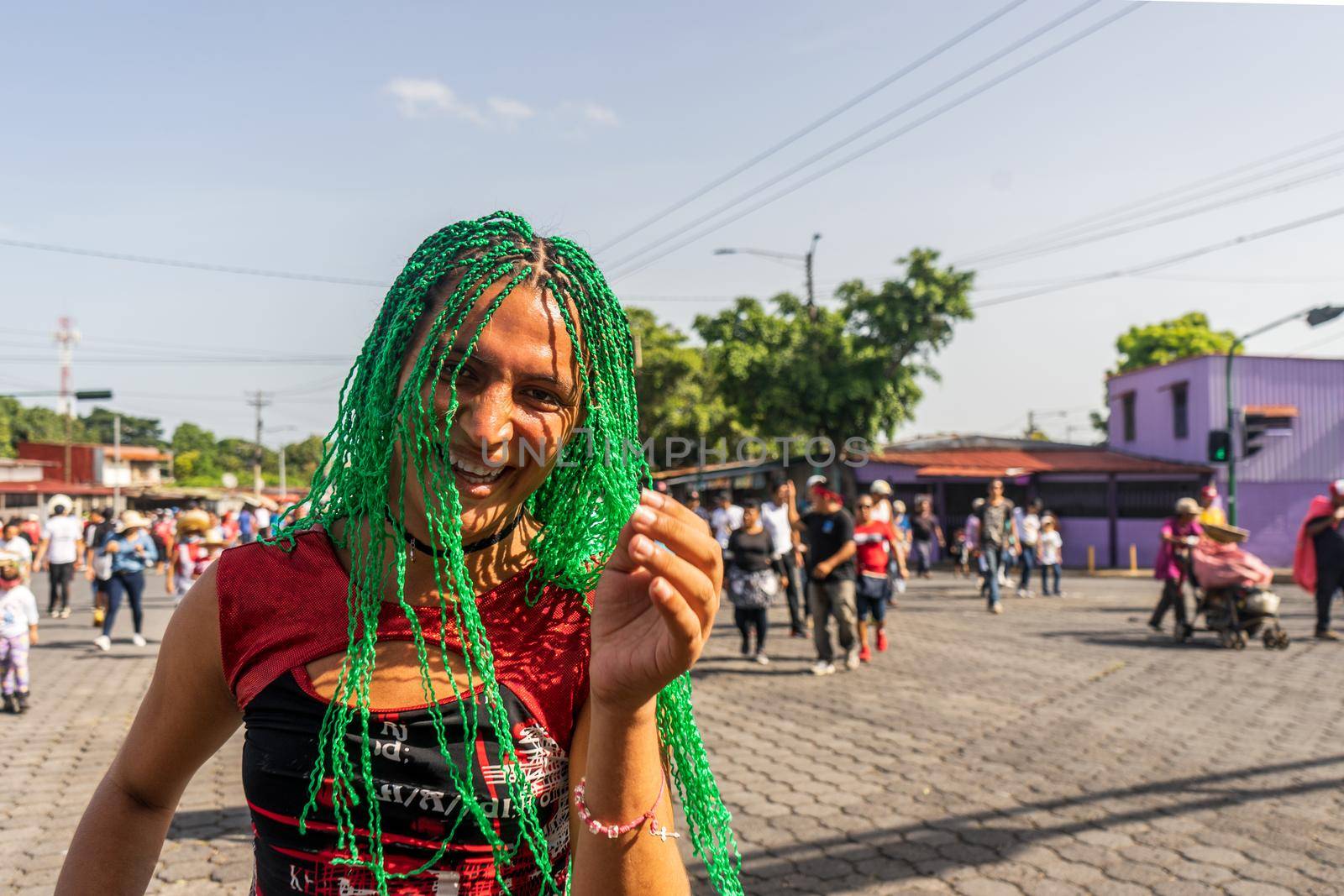 Young transgender woman happy in the streets of Managua during a traditional festival in Nicaragua
