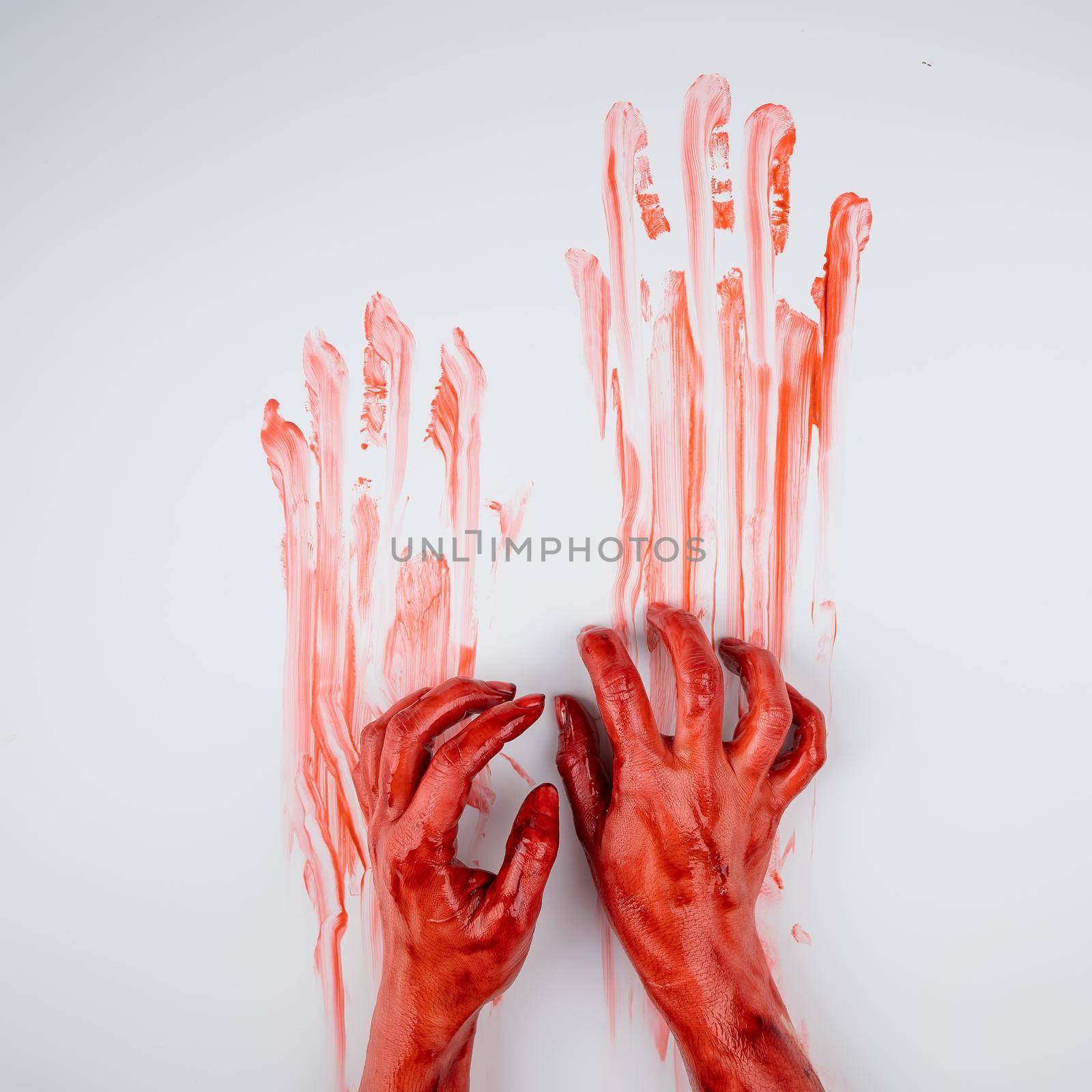 Female hands in blood on a white background