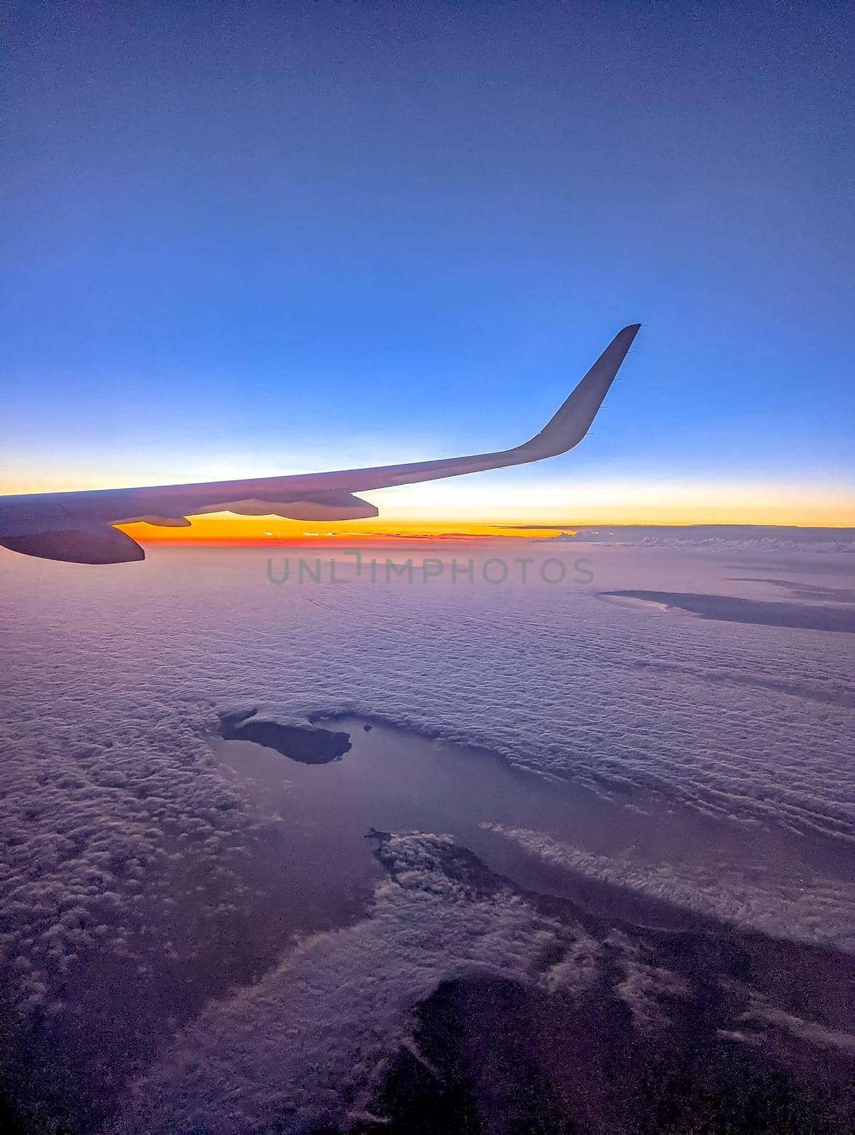 Clouds and sky as seen through window of an aircraft