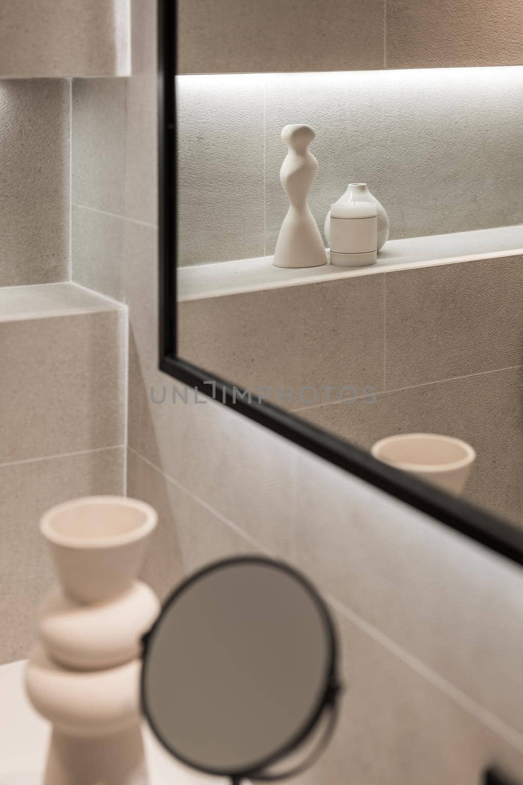 Modern bathroom interior with mirror and decorative elements in reflection. Minimalist style. Selective focus by apavlin