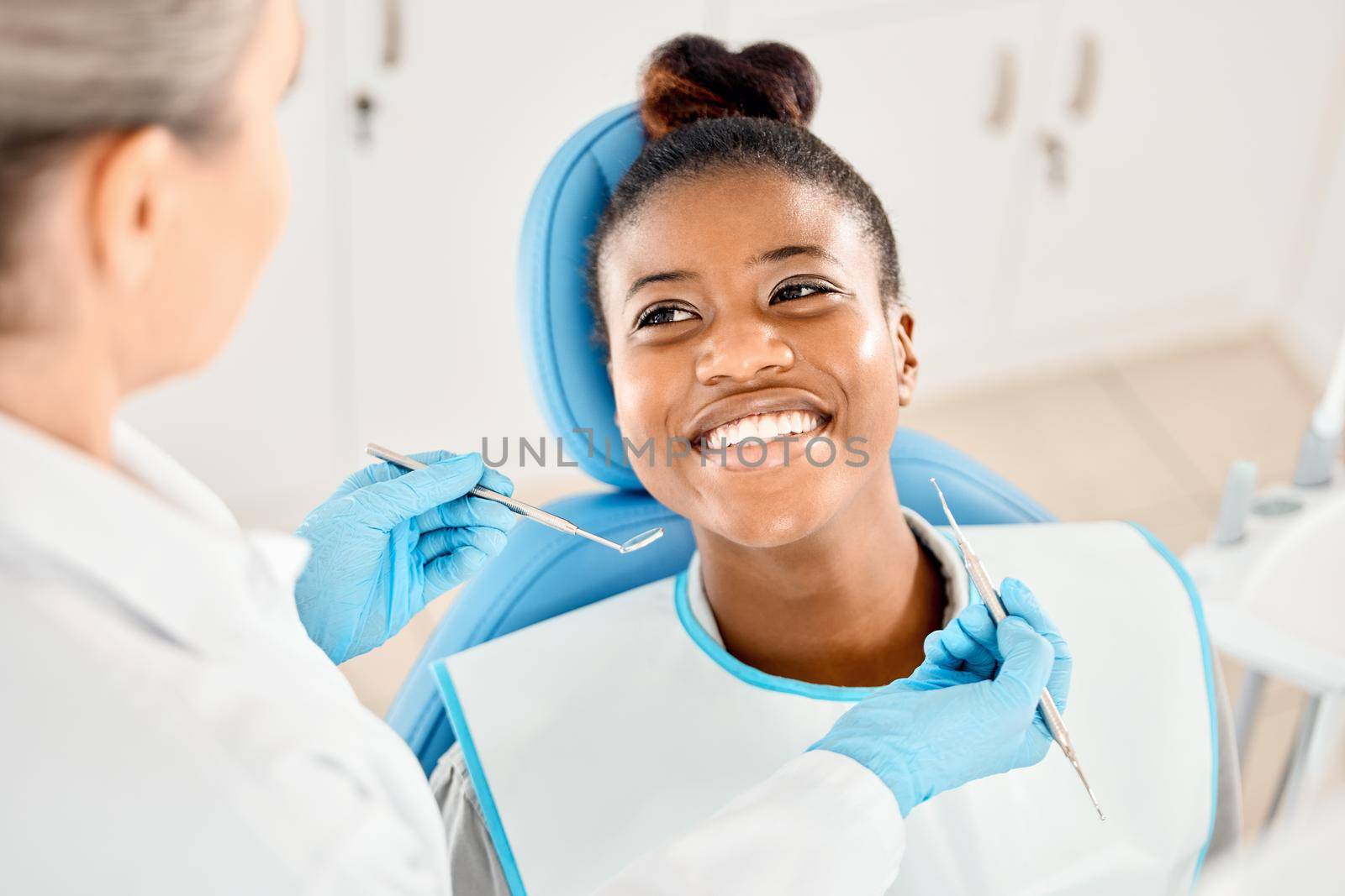 Youve really been caring for your teeth. a young woman at her dental checkup. by YuriArcurs
