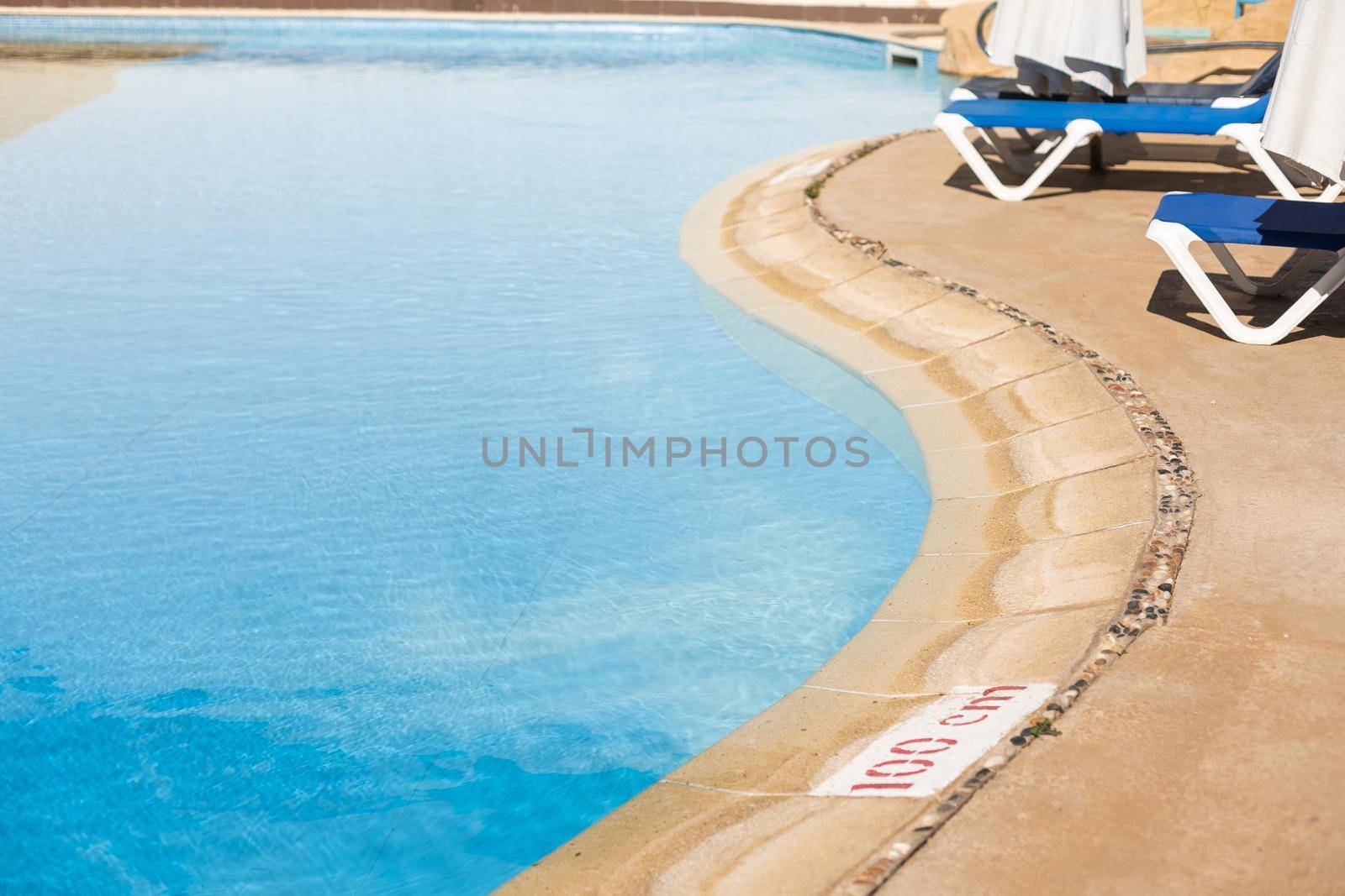 surface of blue swimming pool, background of water in swimming pool. by Andelov13