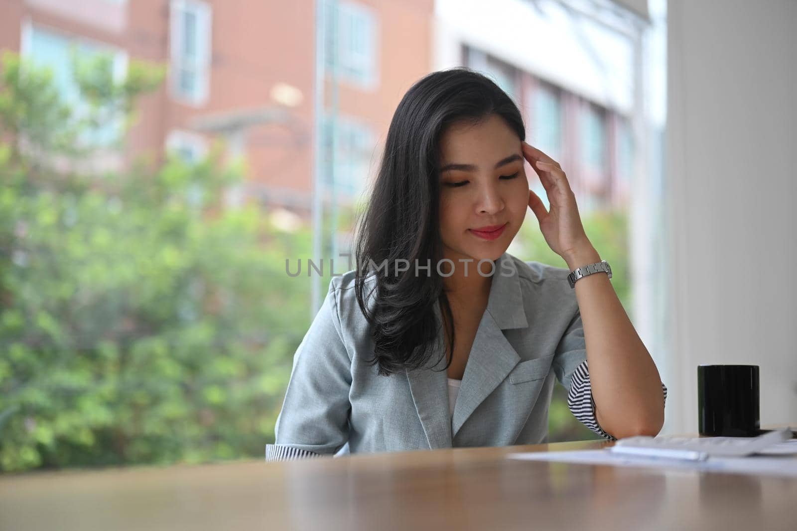 Frustrated young businesswoman having problems at work, feeling dissatisfied with financial report.