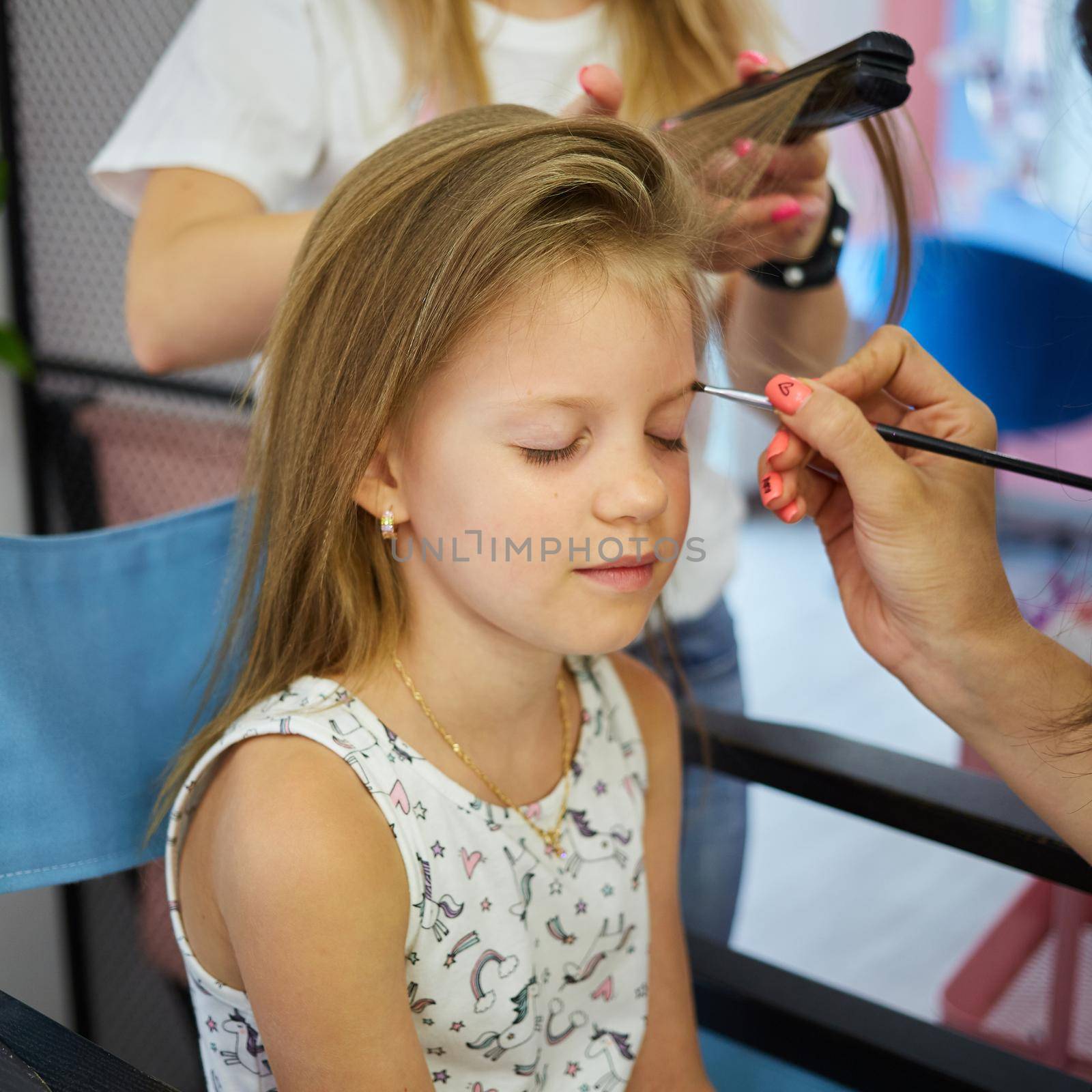 Children make up. Glitter makeup. Sparkles on cheek