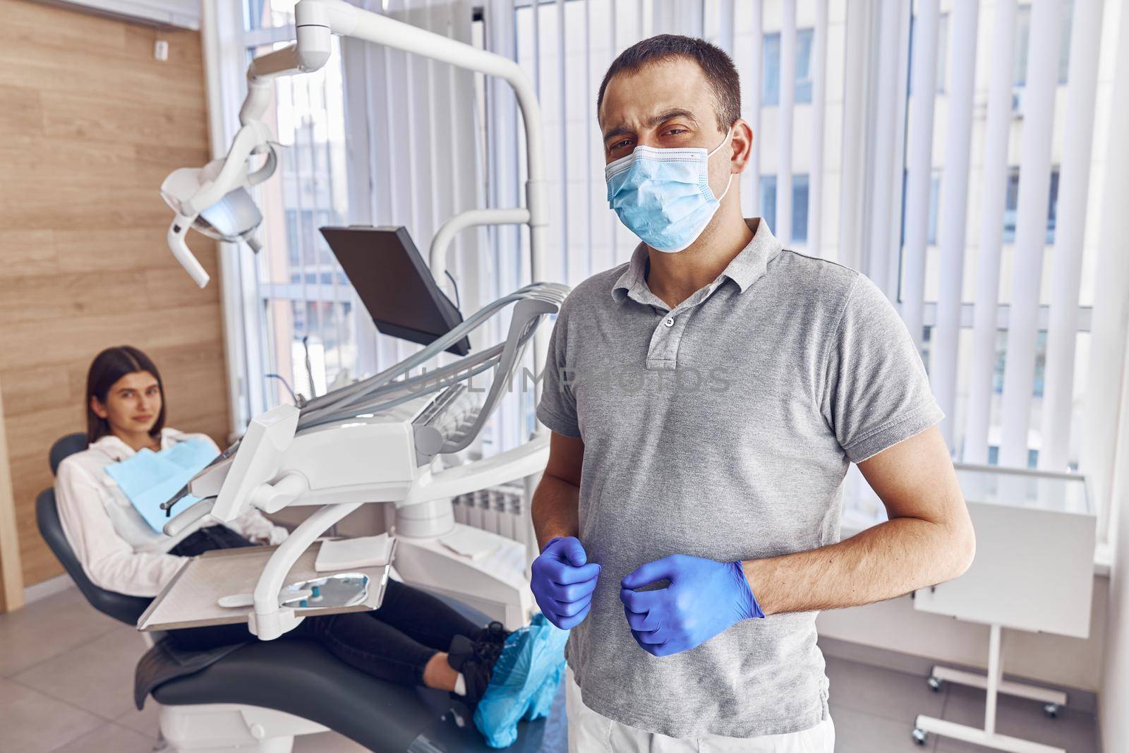 Portrait of confident male dentist in modern stamotology cabinet by Yaroslav_astakhov