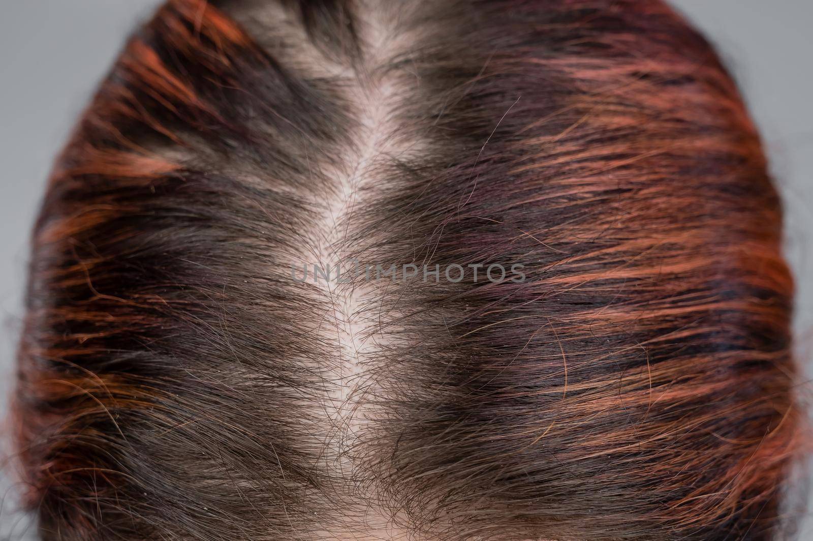 Close-up of a female head parting. by mrwed54