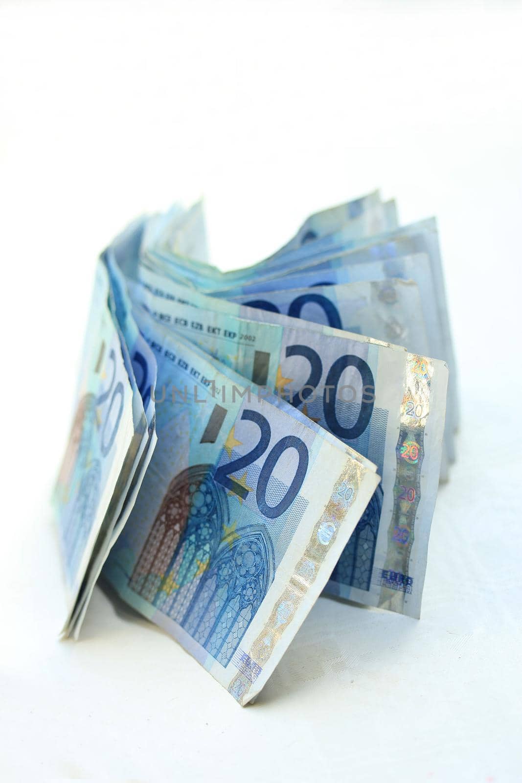 stacked 20 euro banknotes on white background