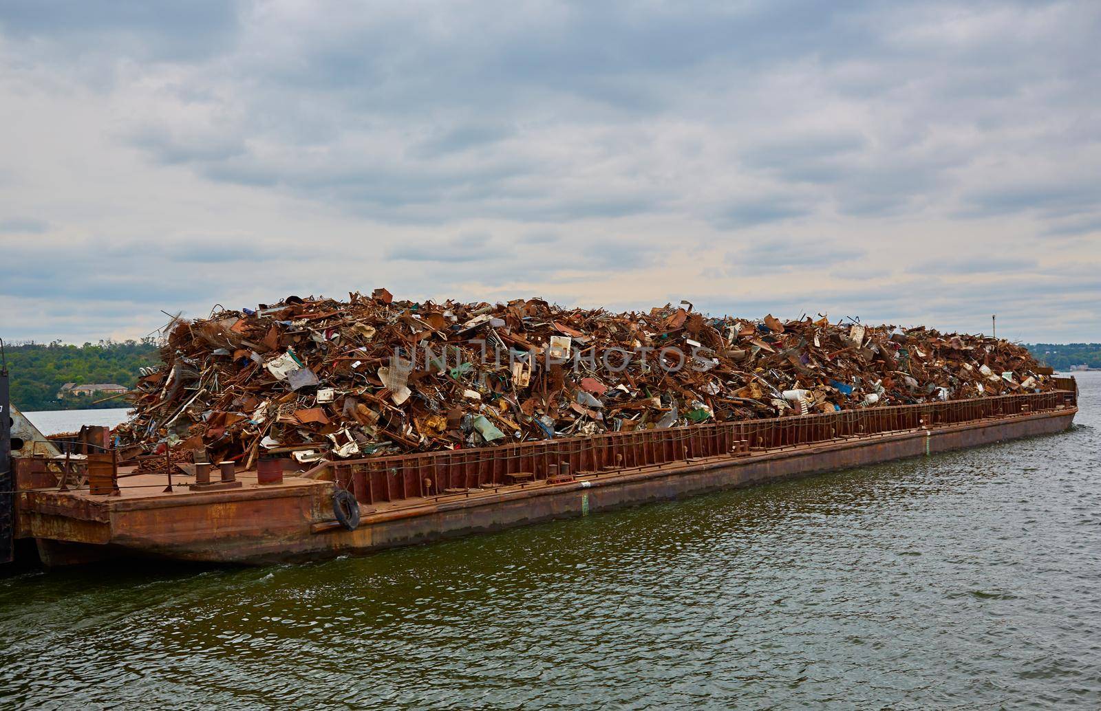 Transportation industry. Ship barge transports scrap metal and sand with gravel.