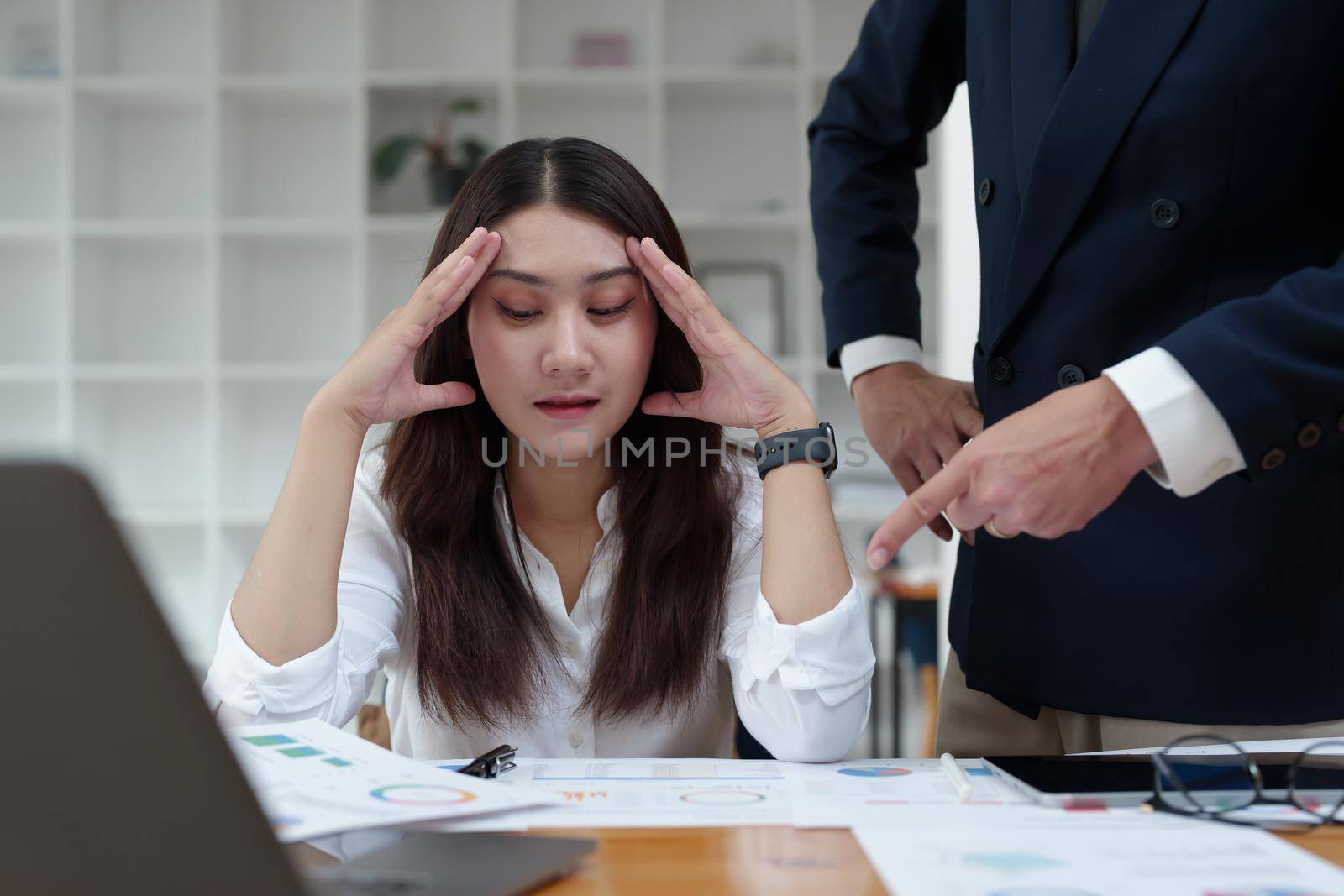 The portrait of an Asian female worker was warned by her supervisor as the profitability sales did not meet the planned targets.