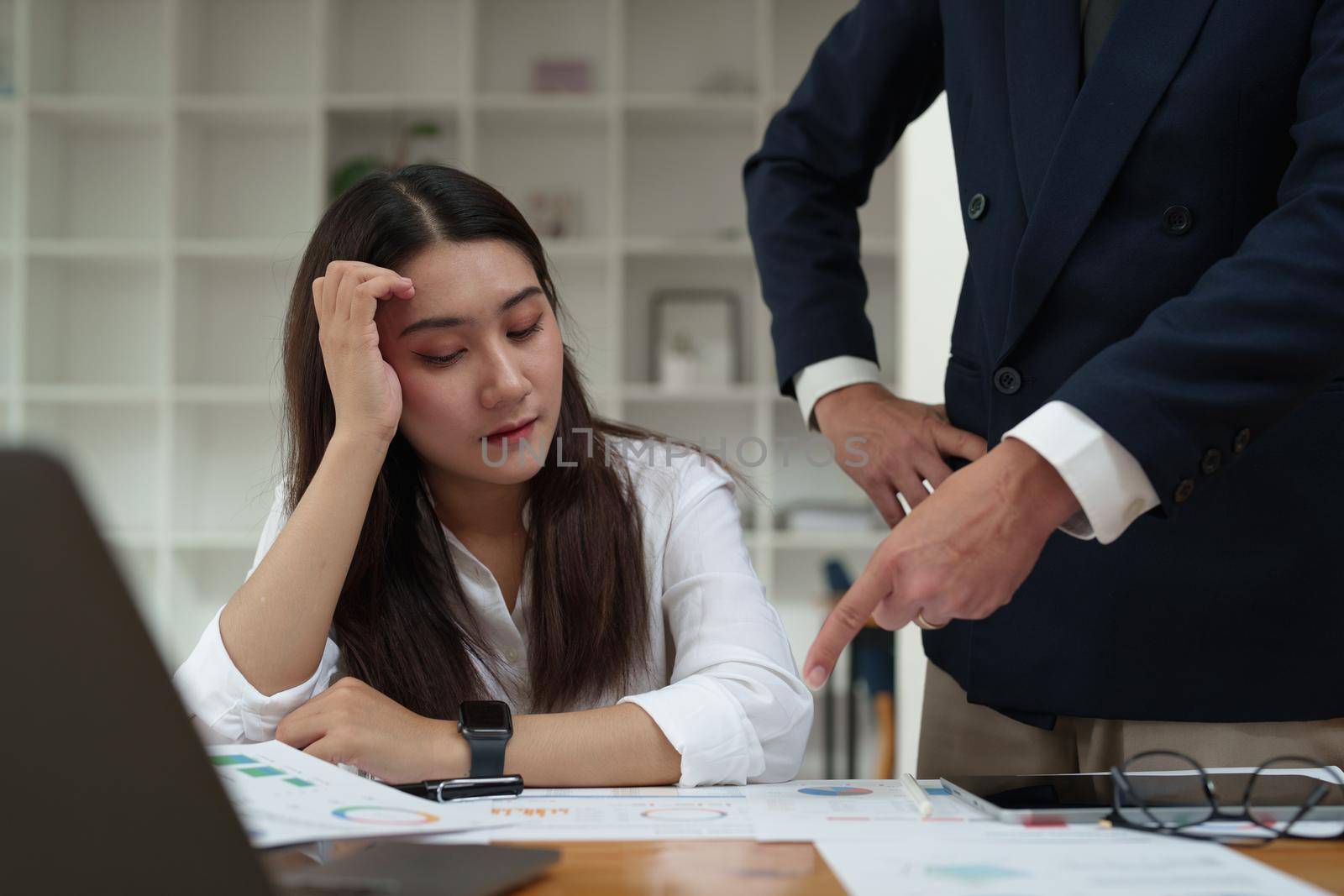 The portrait of an Asian female worker was warned by her supervisor as the profitability sales did not meet the planned targets by Manastrong