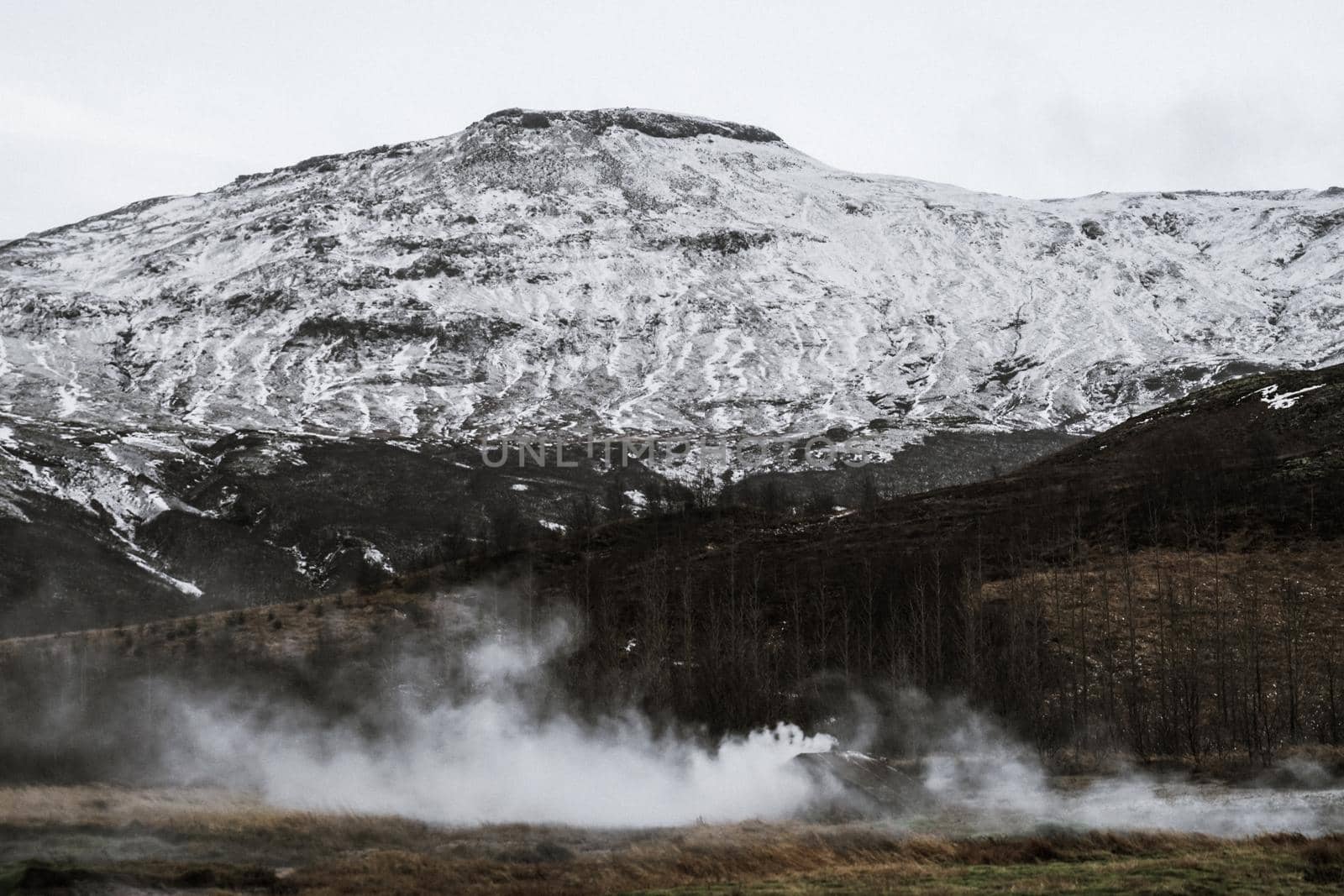 Icelands snowy mountain and blue sky. Shooting Location: Iceland, Lay Cavik