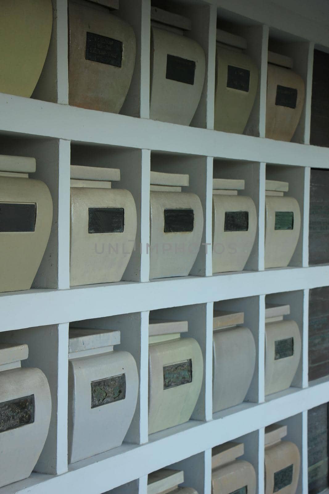 Urns with ashes in a columbarium wall