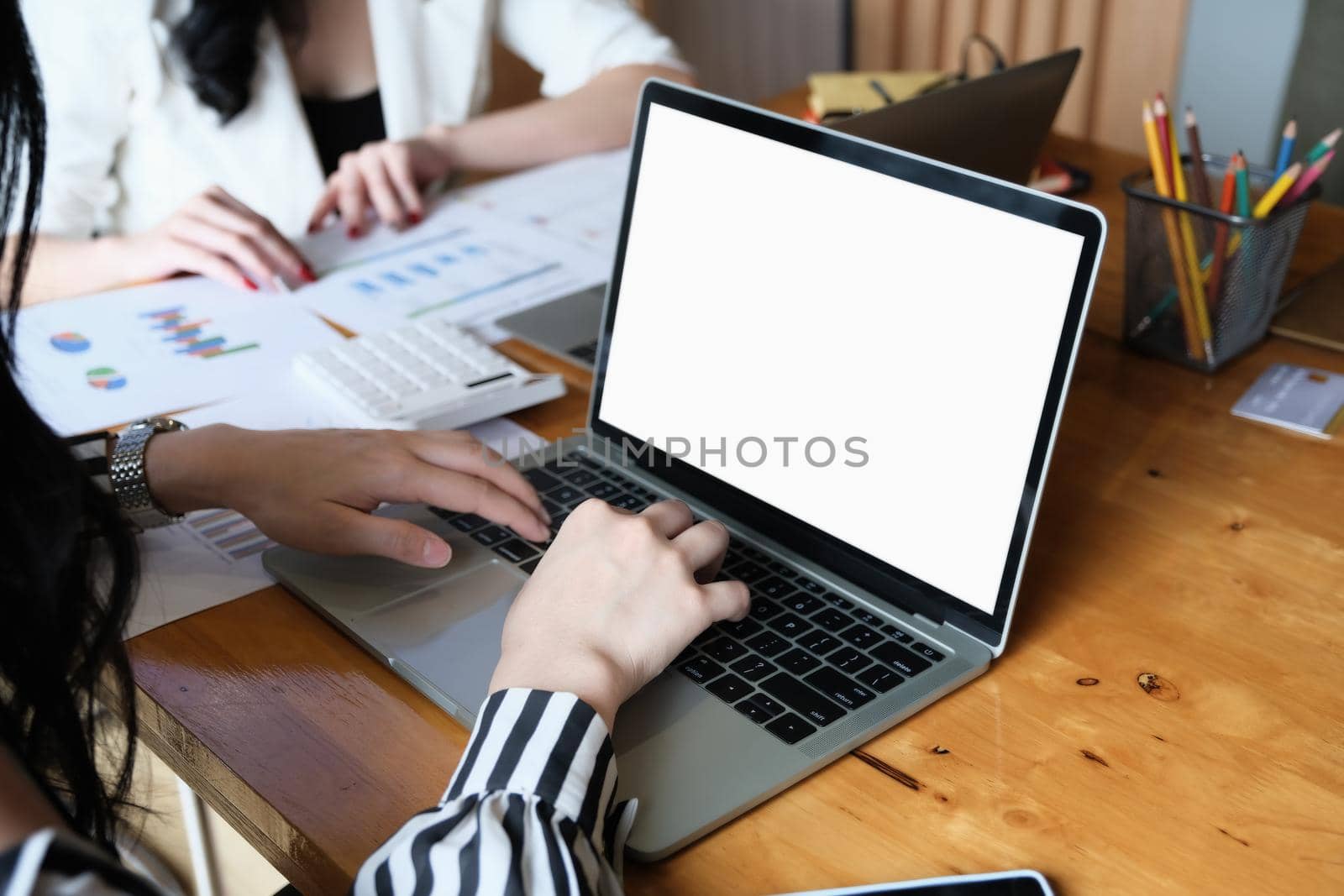 freelance concept, Woman using computers laptop on wooden desk blur background. Laptop computer with blank screen and can be add your texts or others on screen