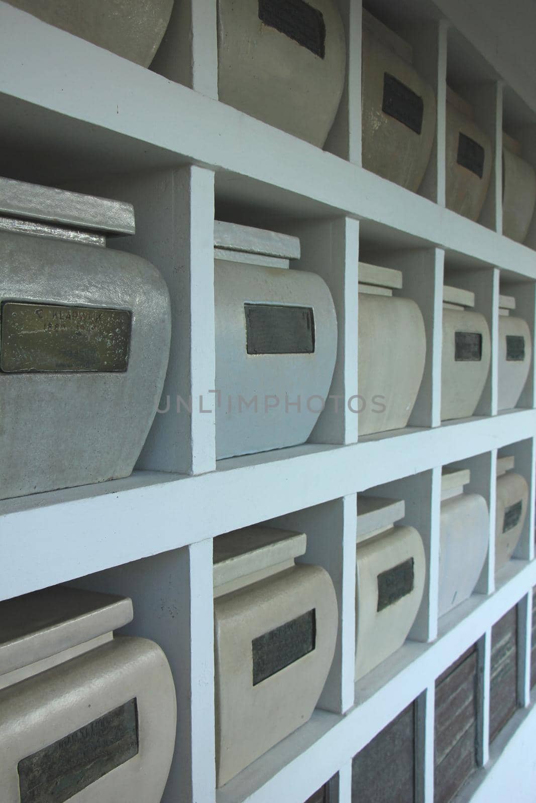 Urns with ashes in a columbarium wall