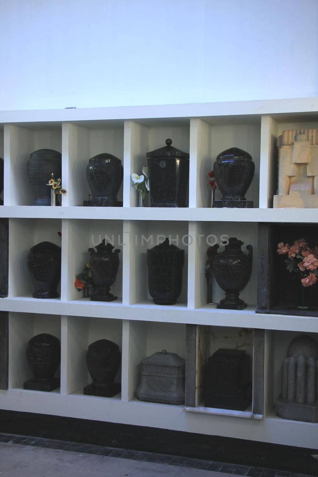 Urns with ashes in a columbarium wall