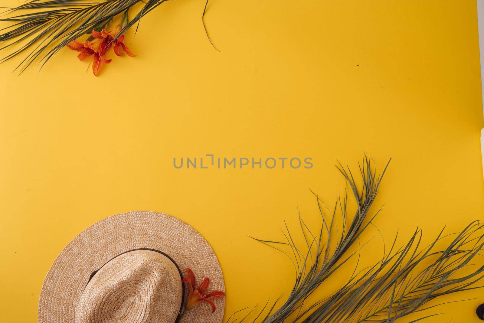 ummer background with straw hat and bag and palm leaves. High quality photo