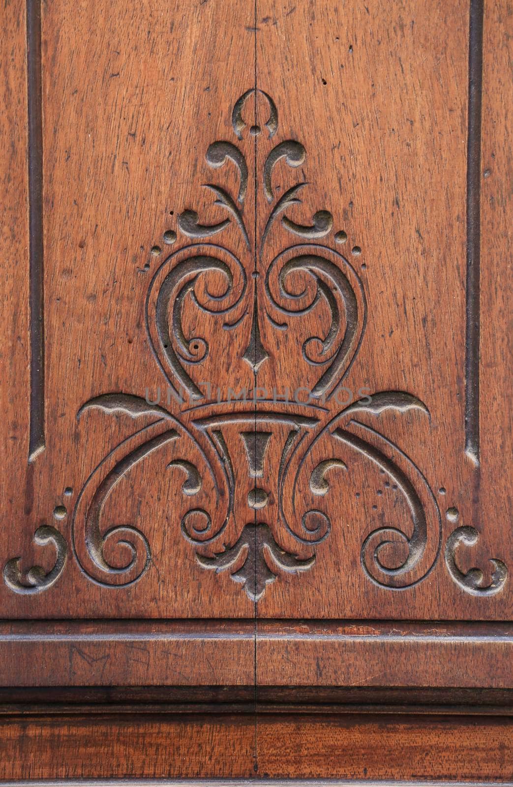 Carved details on vintage wooden door by soniabonet