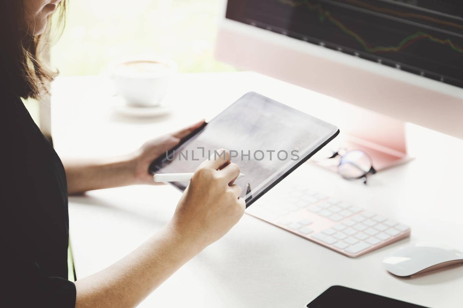 New normal, self-employed women hand holding pen are using tablet and computer laptop to trade stocks for profit, buying and selling