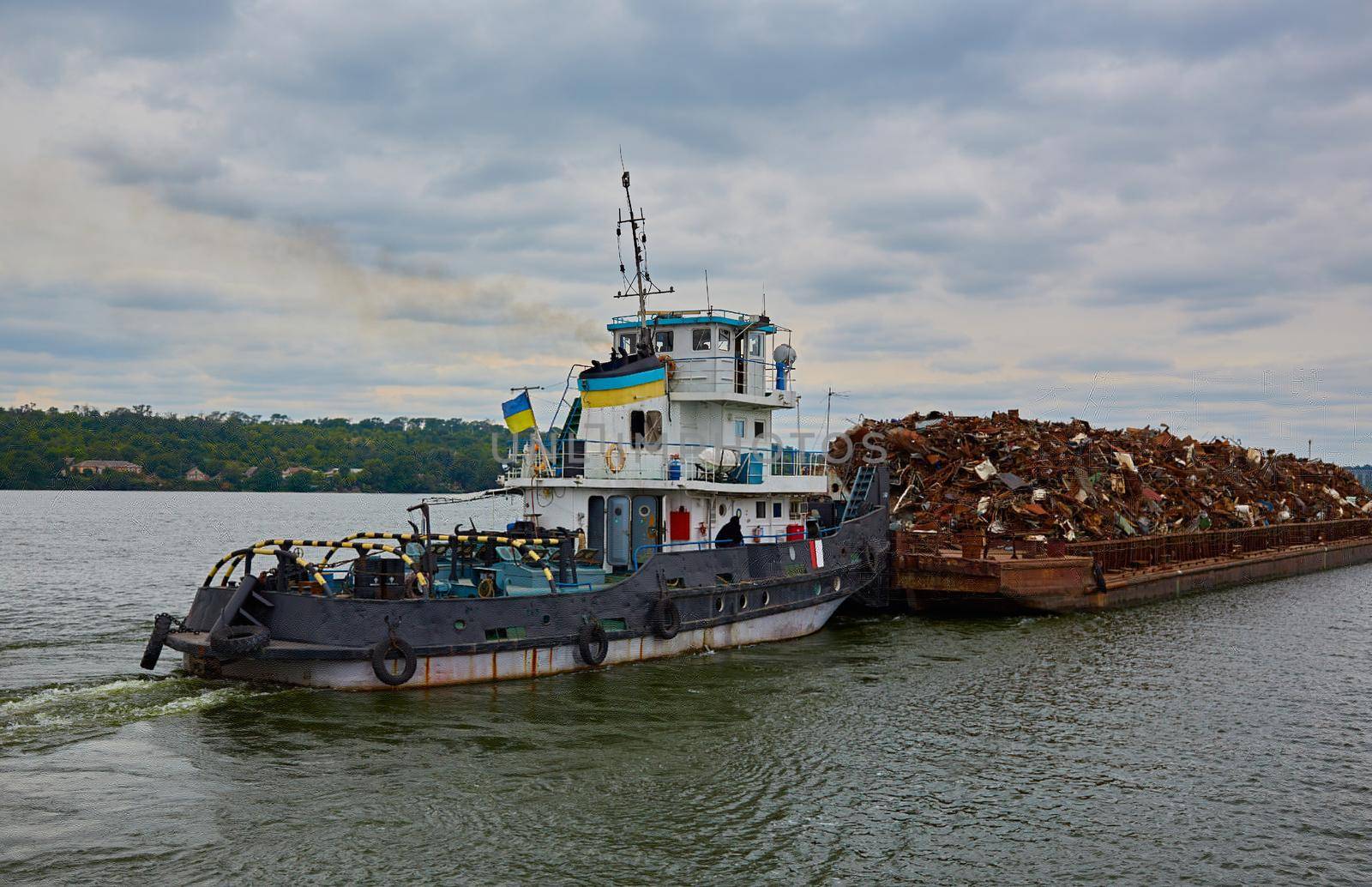 Transportation industry. Ship barge transports scrap metal and sand with gravel.