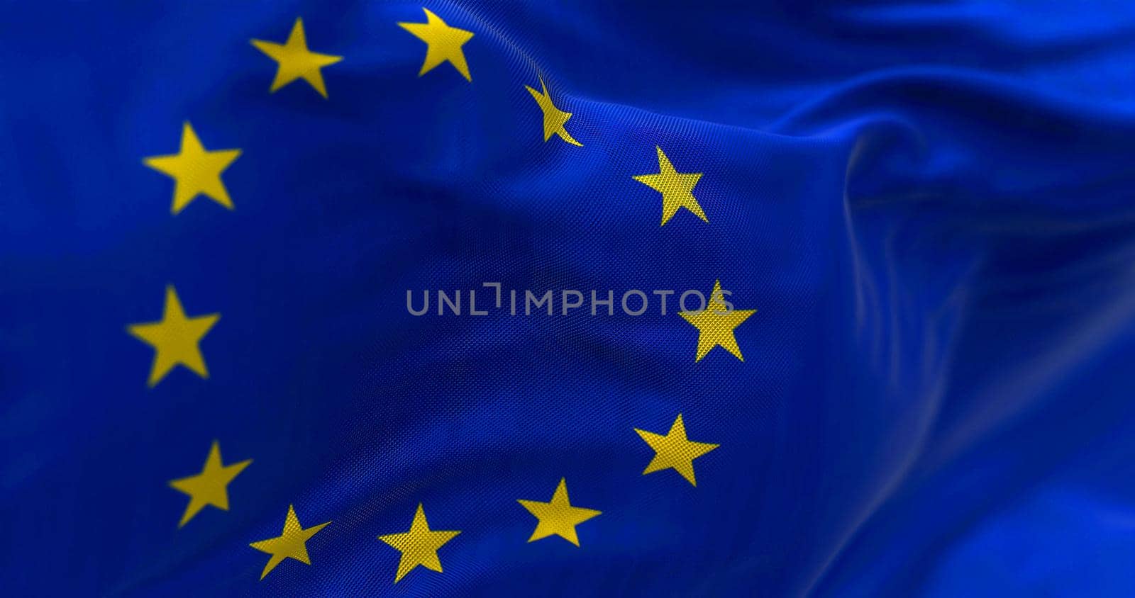 Close-up view of the European Union flag waving in the wind. The European Union is a political and economic union of 27 member states that are located primarily in Europe