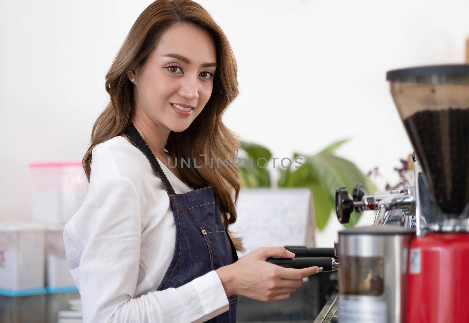 Startup successful small business owner sme beauty girl stand with tablet smartphone in coffee shop restaurant. Portrait of asian tan woman barista cafe owner. SME entrepreneur seller business concept.