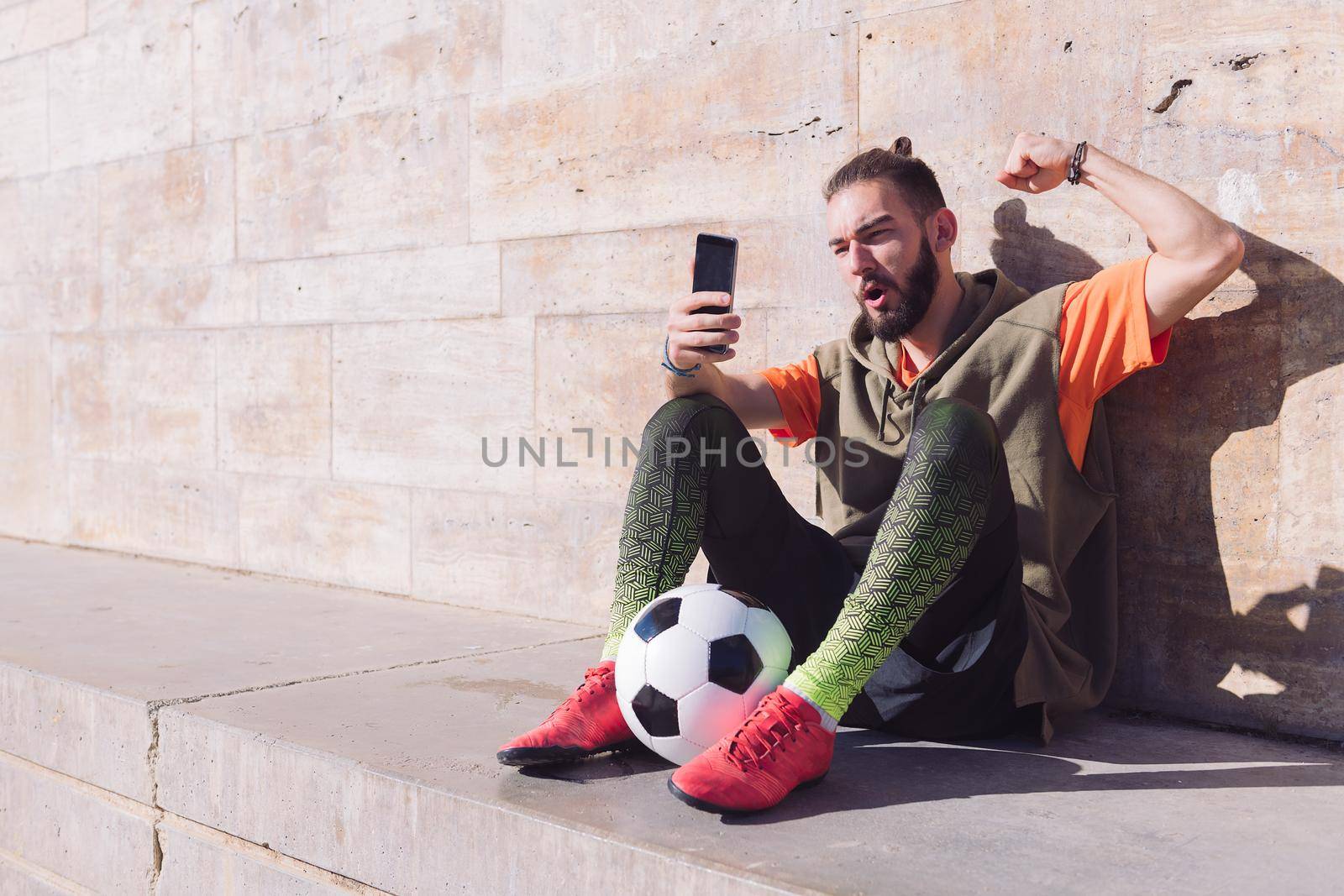 soccer fan celebrates victory consulting phone by raulmelldo