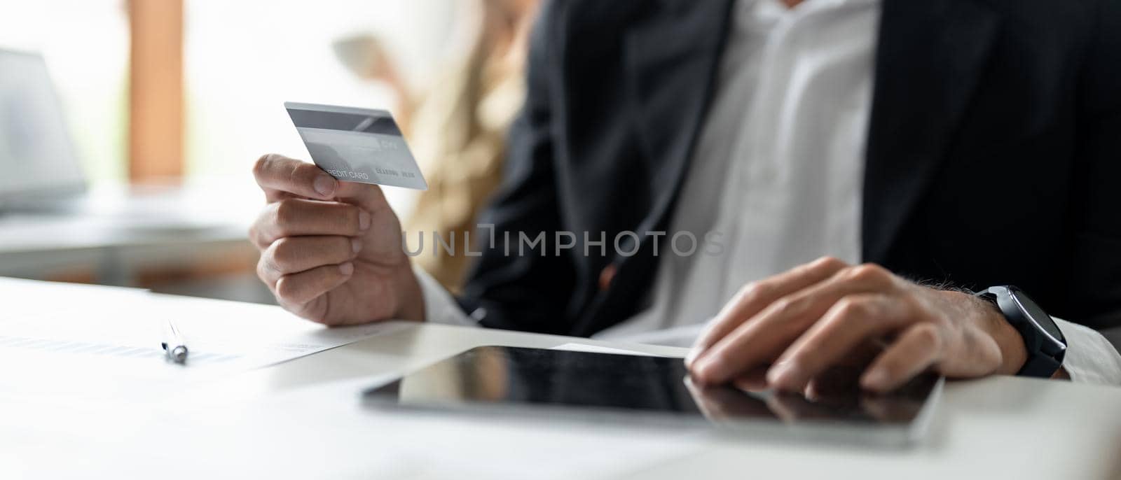 Man hands holding credit card and using laptop. Online shopping by nateemee