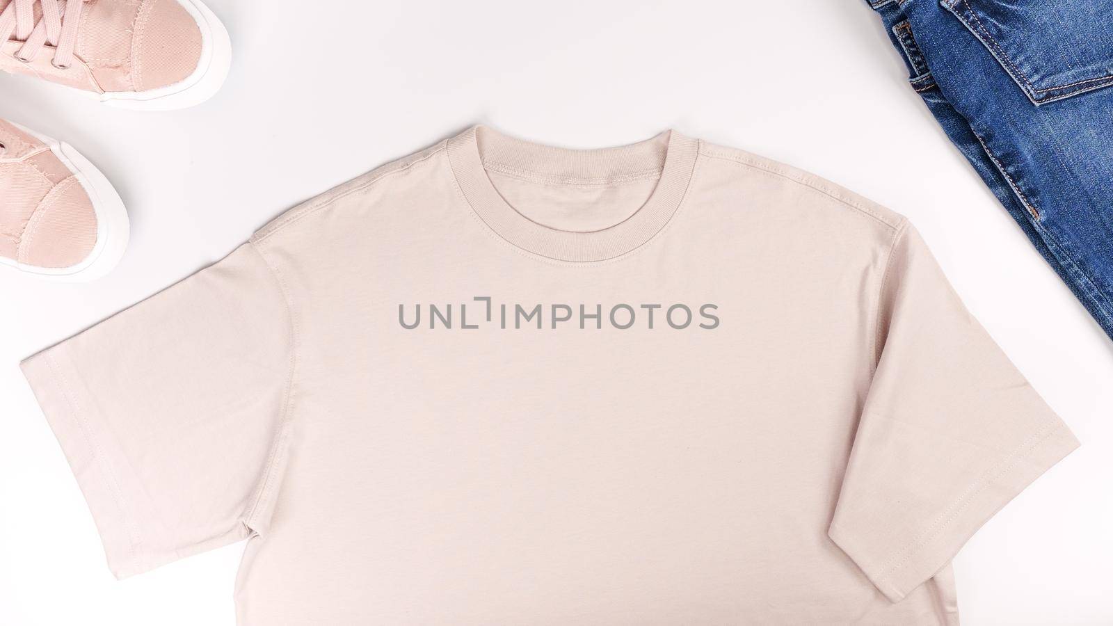 Beige unisex t shirt mock up flat lay on white background. Top front view t-shirt, snikers, jeans and copy space. Mockup t-shirt and summertime. Template blank shirt. by JuliaDorian