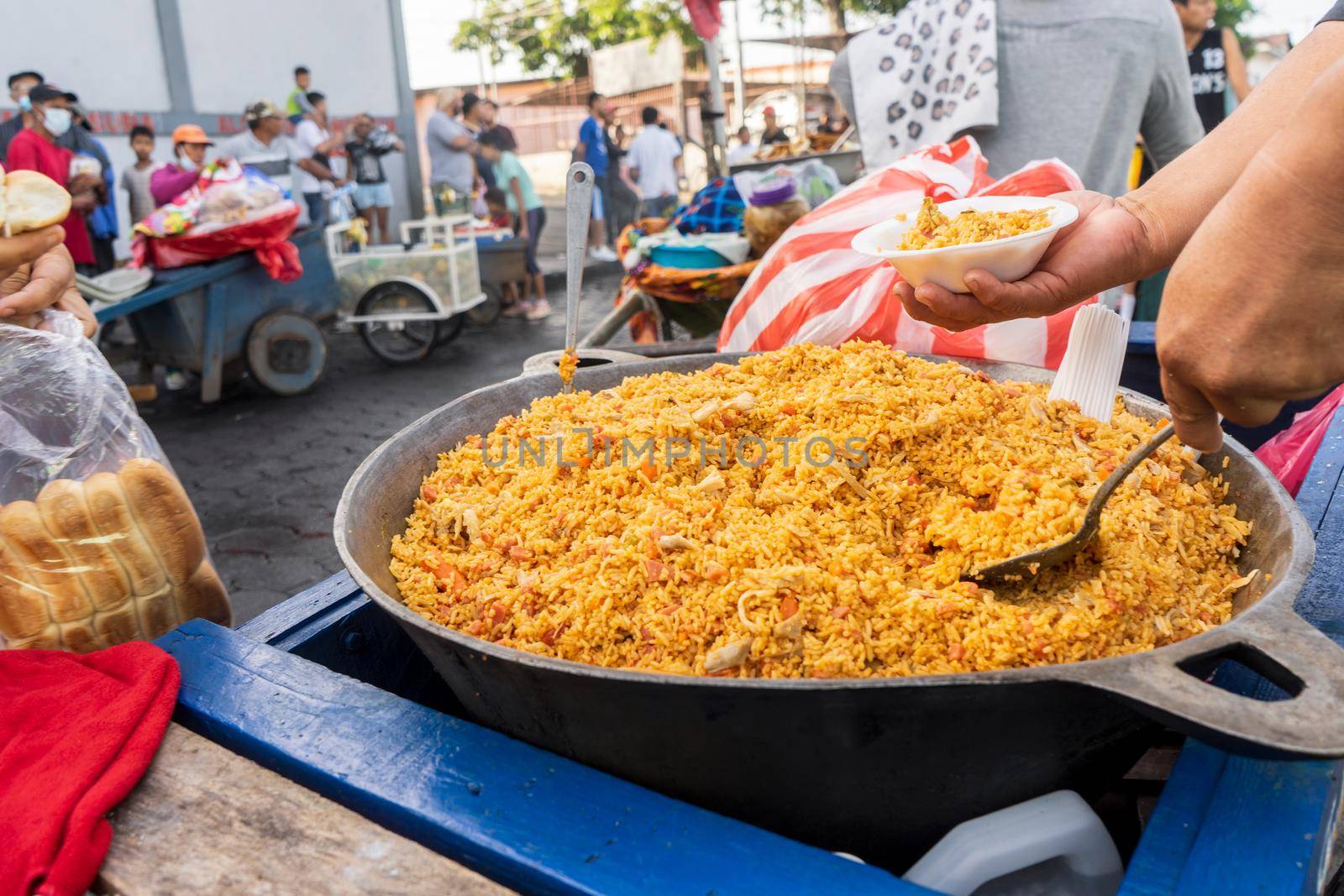 Unrecognizable man selling Valencian rice in the streets of Managua