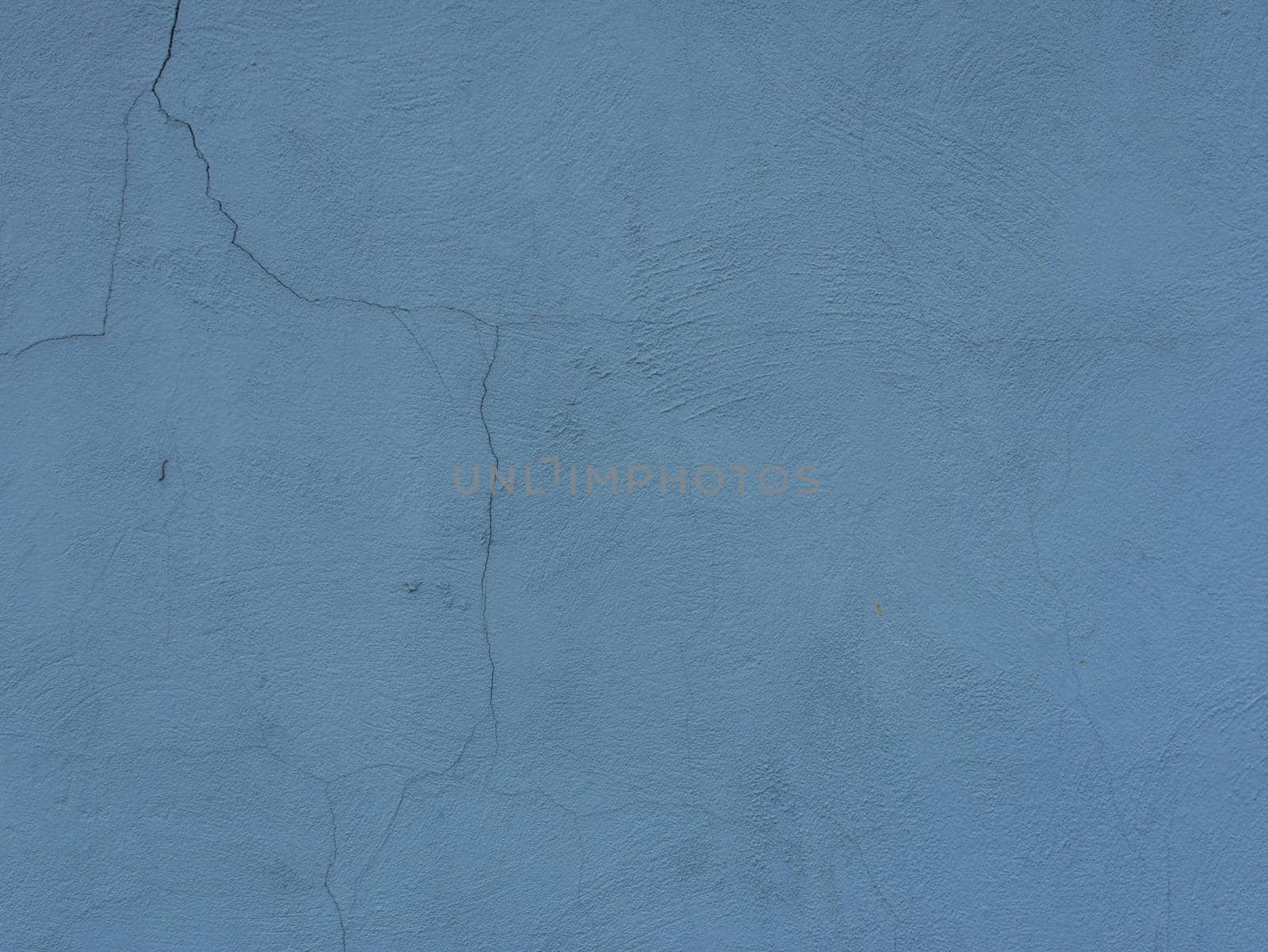 Abstract background of blue old shabby cracked plaster.