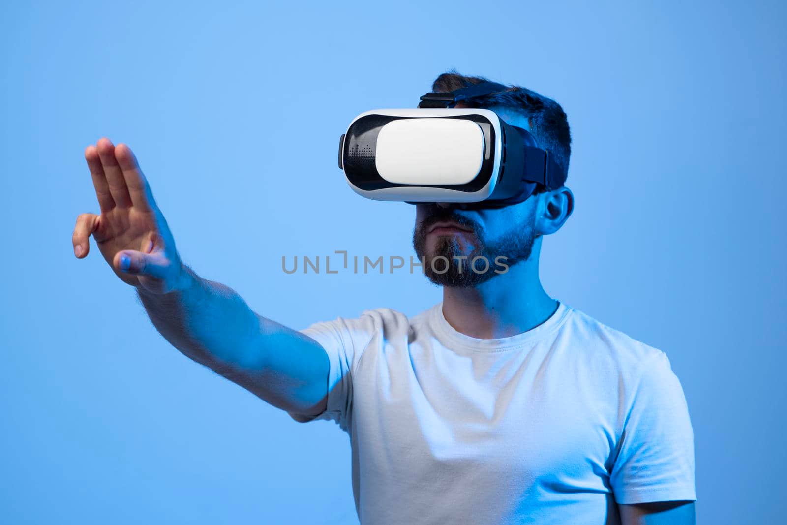 Closeup portrait of a man wearing VR goggles, working over virtual project, enjoying new reality, playing video game. Technology, innovation gadgets