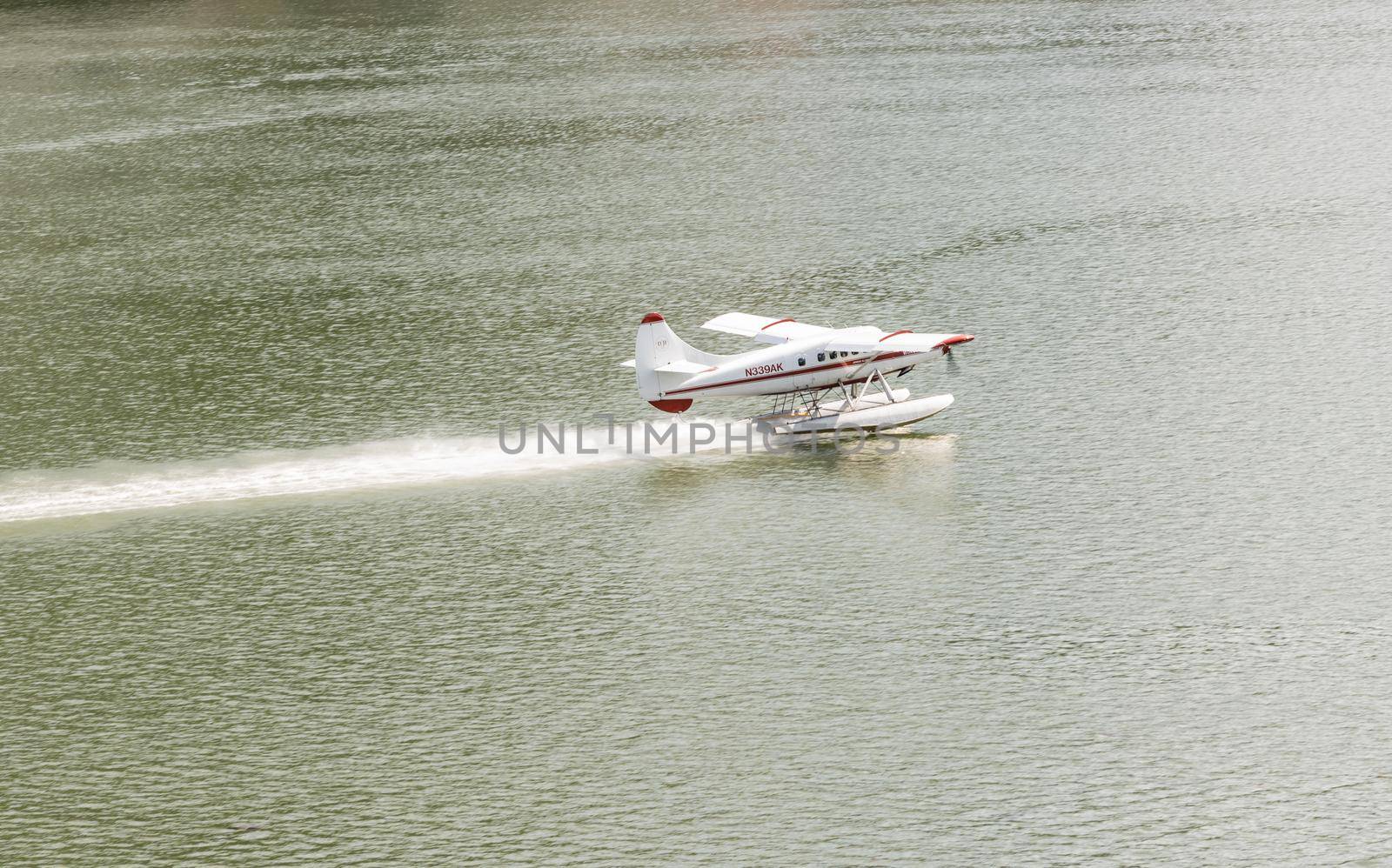 Juneau, AK - 9 June 2022: Wings Air seaplane taking off in the harbor of Juneau