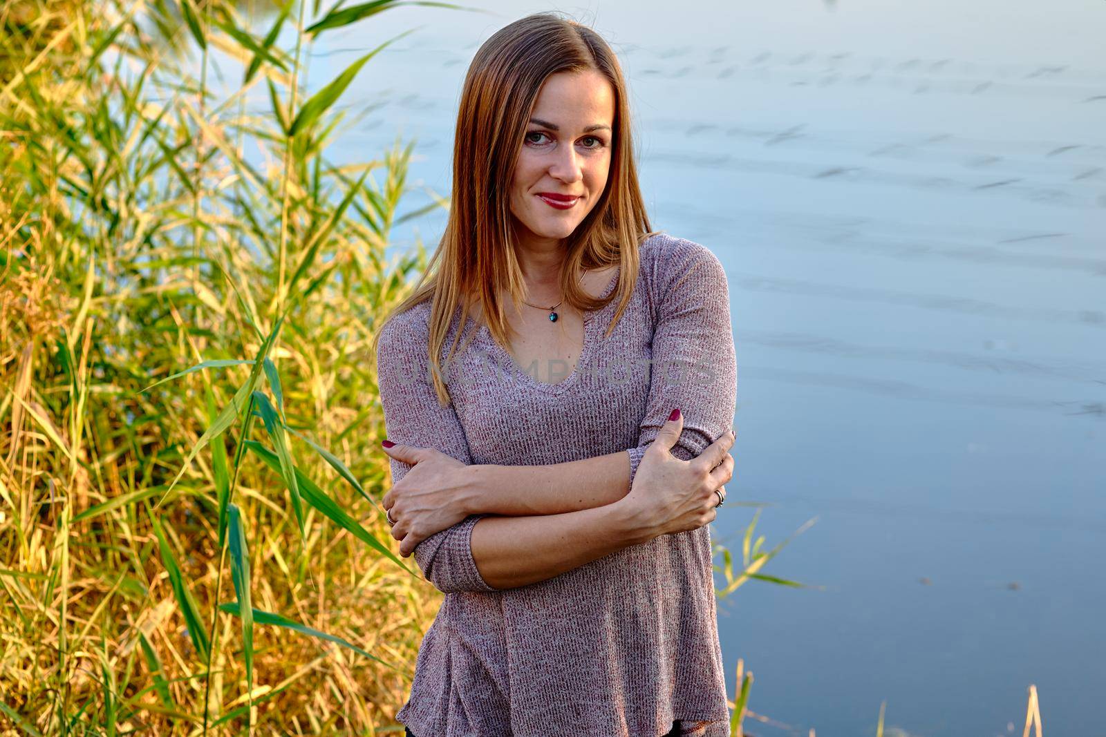 Portrait of a cute young woman with brown fair hair and golden autumn leaves by jovani68