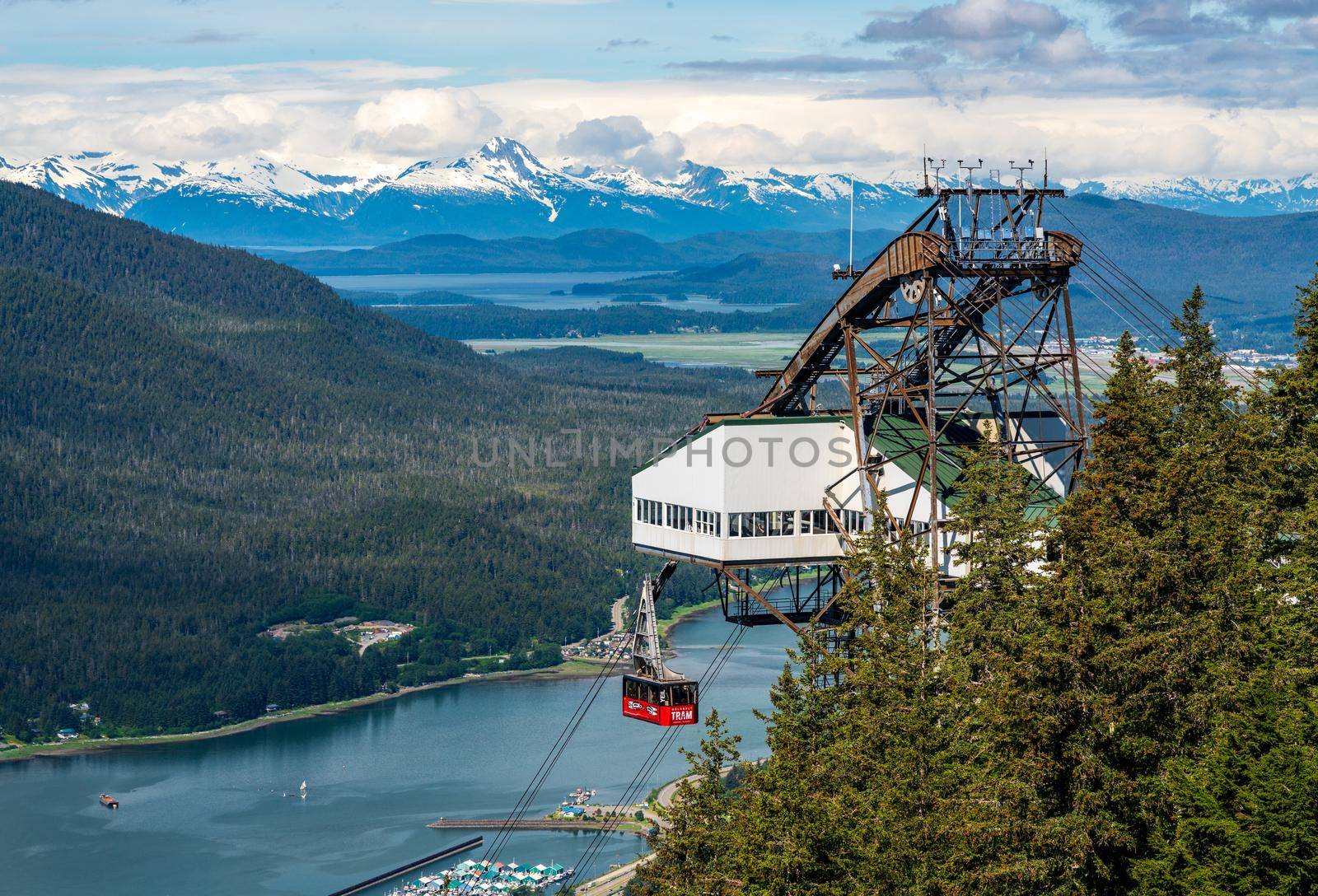 Juneau, AK - 9 June 2022: Passengers arriving at the mountain in the red cable car car of Goldbelt tram