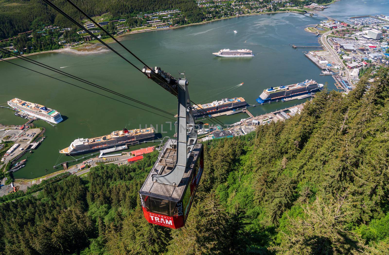 Juneau, AK - 9 June 2022: Passengers arriving at the mountain in the red cable car car of Goldbelt tram