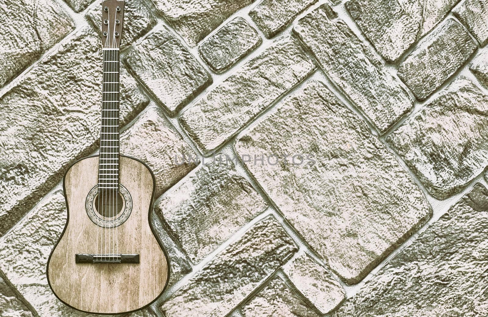 a brief record of facts, topics, or thoughts, written down as an aid to memory. a stringed musical instrument, with a fretted fingerboard. acoustic guitar on gray brick wall. High quality photo