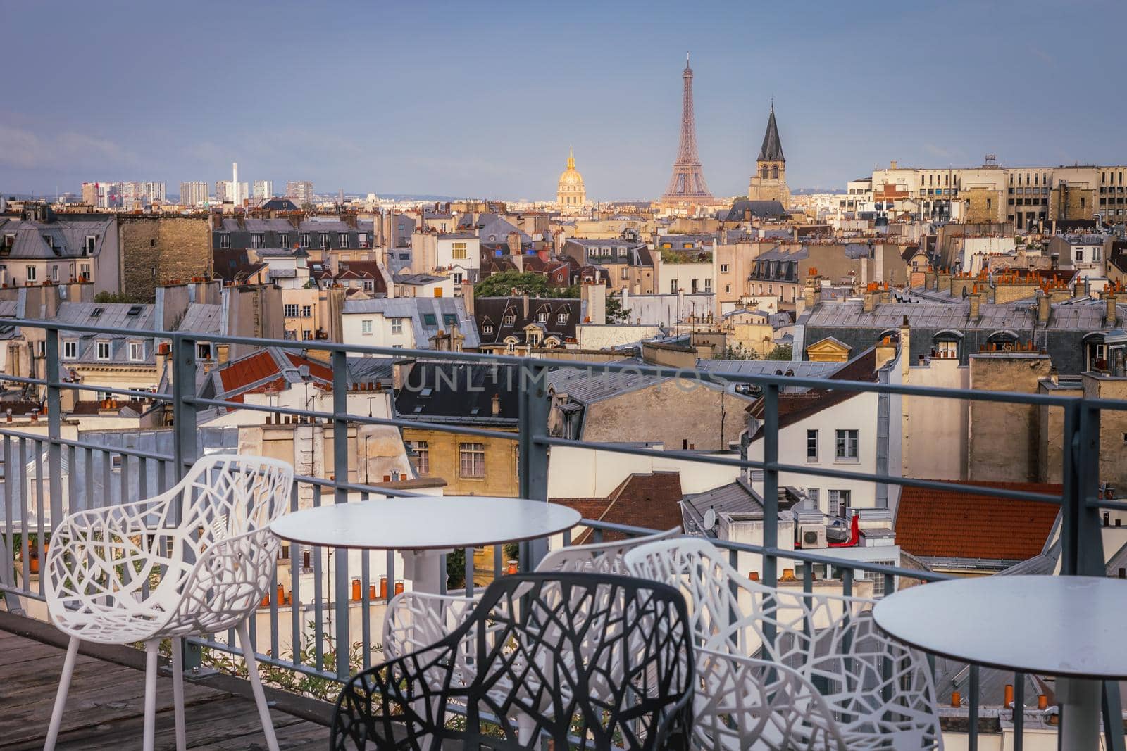 Eiffel tower and parisian roofs at golden sunrise Paris, France