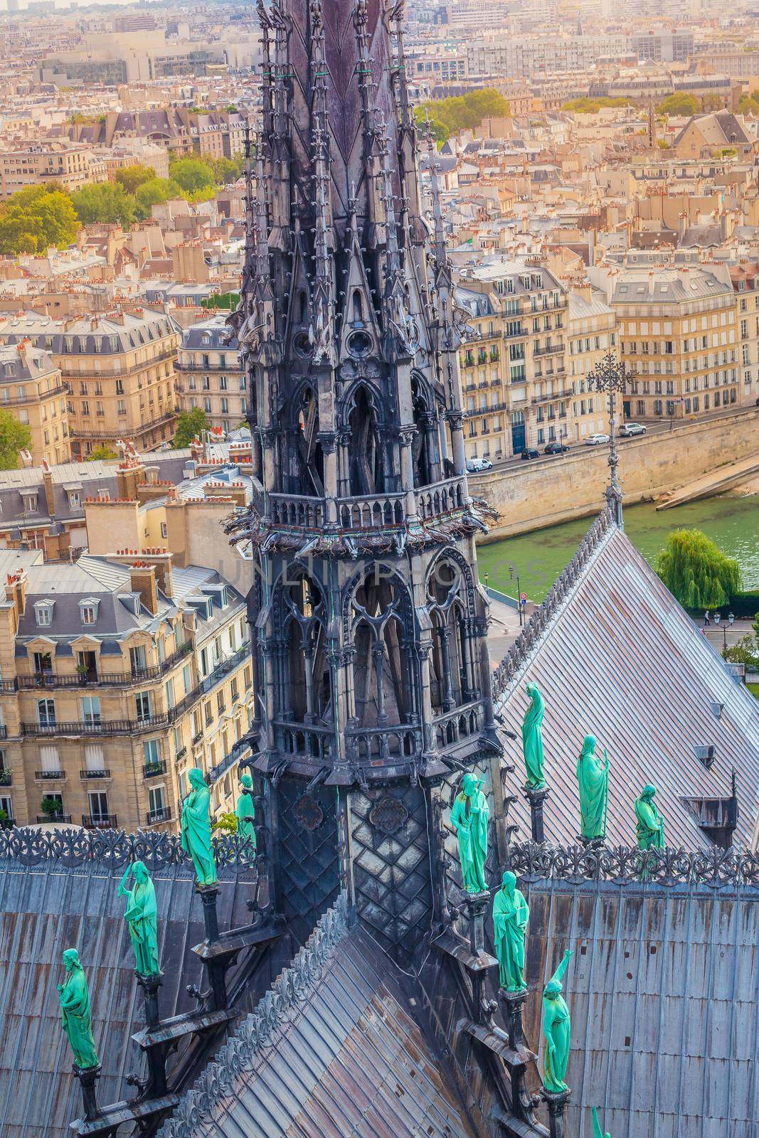 Gothic Notre Dame Cathedral of Paris spire from above with statues, France