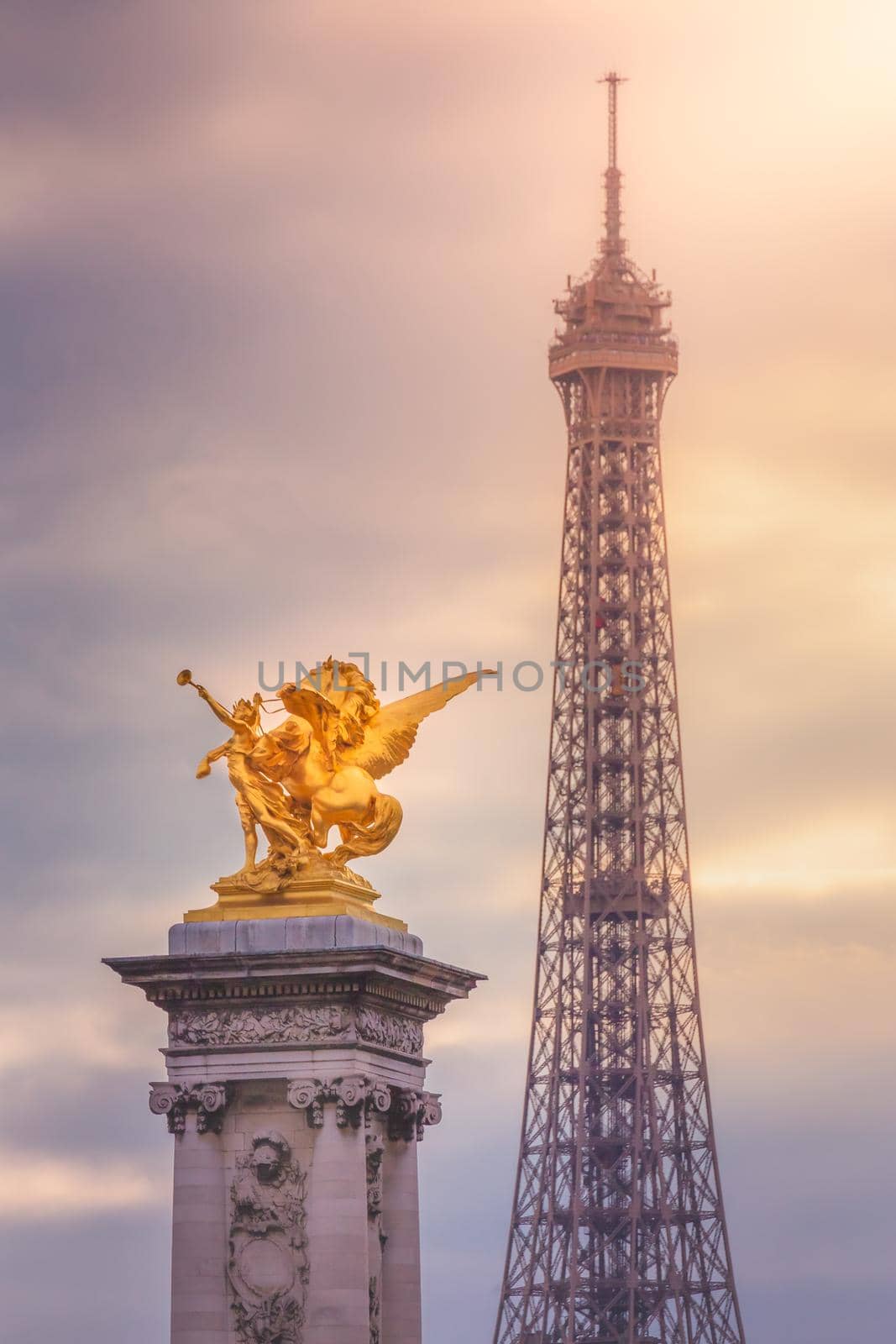 Eiffel Tower and Pont Alexandre III statue at dramatic sunset, Paris, france