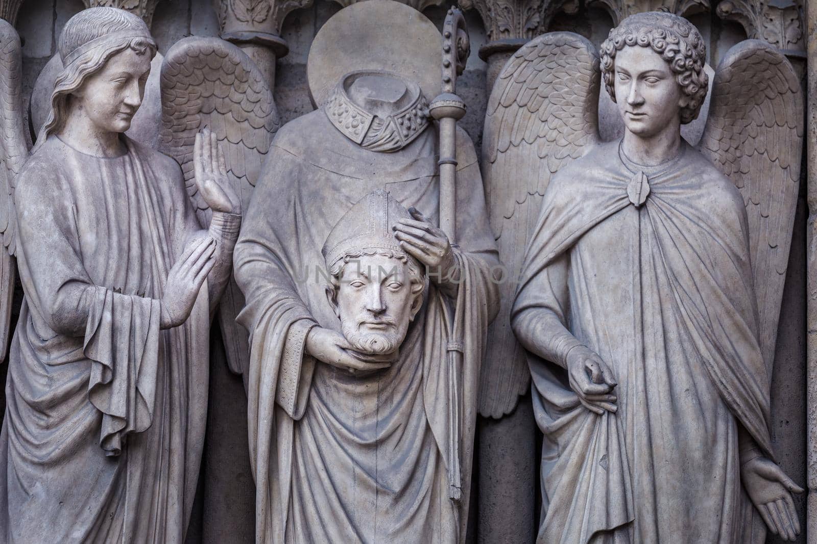 Saint Denis without head and angel, Notre dame , Paris, France