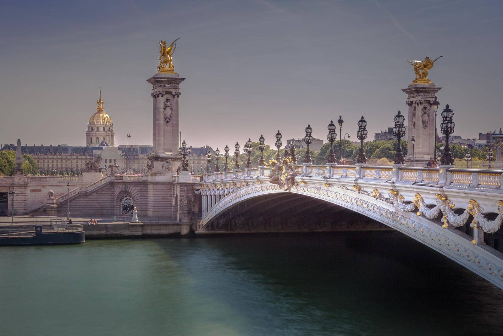 Line of Street lights and Invalides dome in Pont Alexandre III, Paris, france