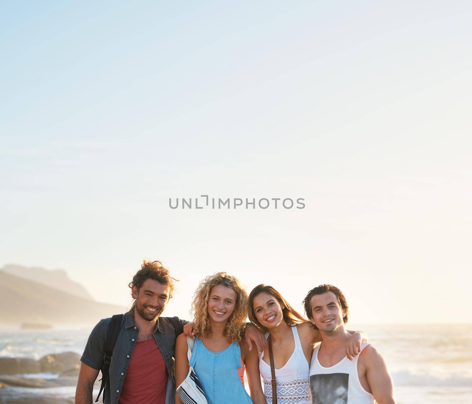 group of friends posing on beach having fun summer vacation lifestyle on seaside at sunset by YuriArcurs