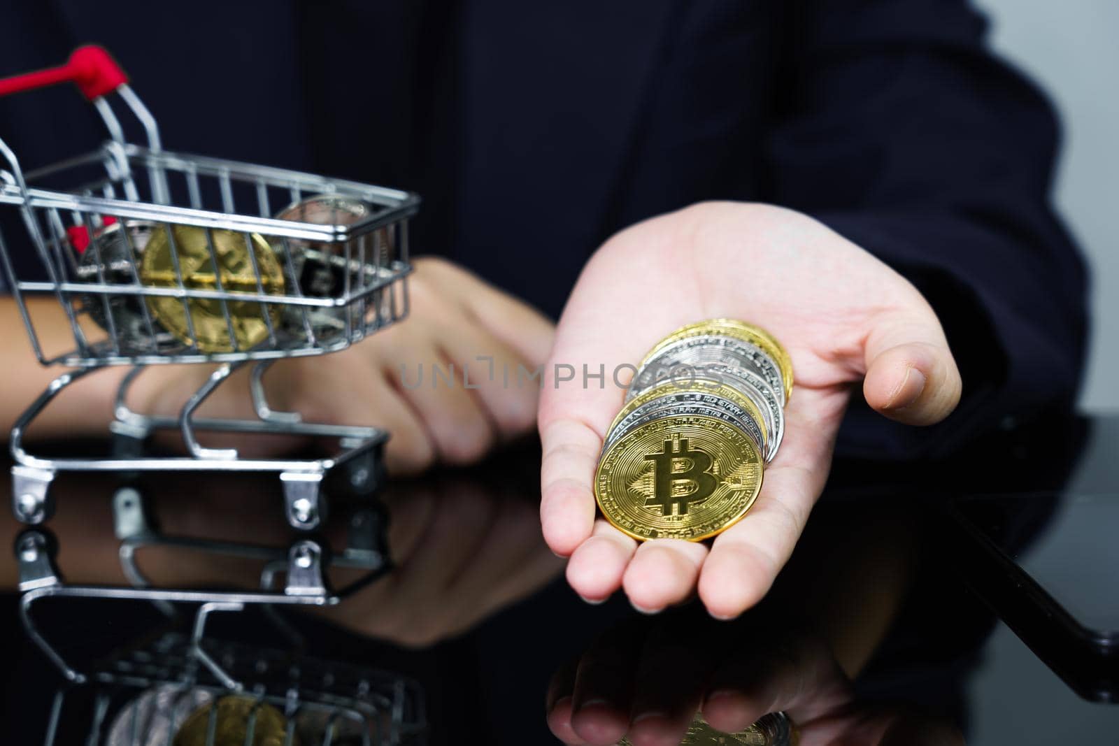 Closeup image of a business women holding and giving golden color bitcoins