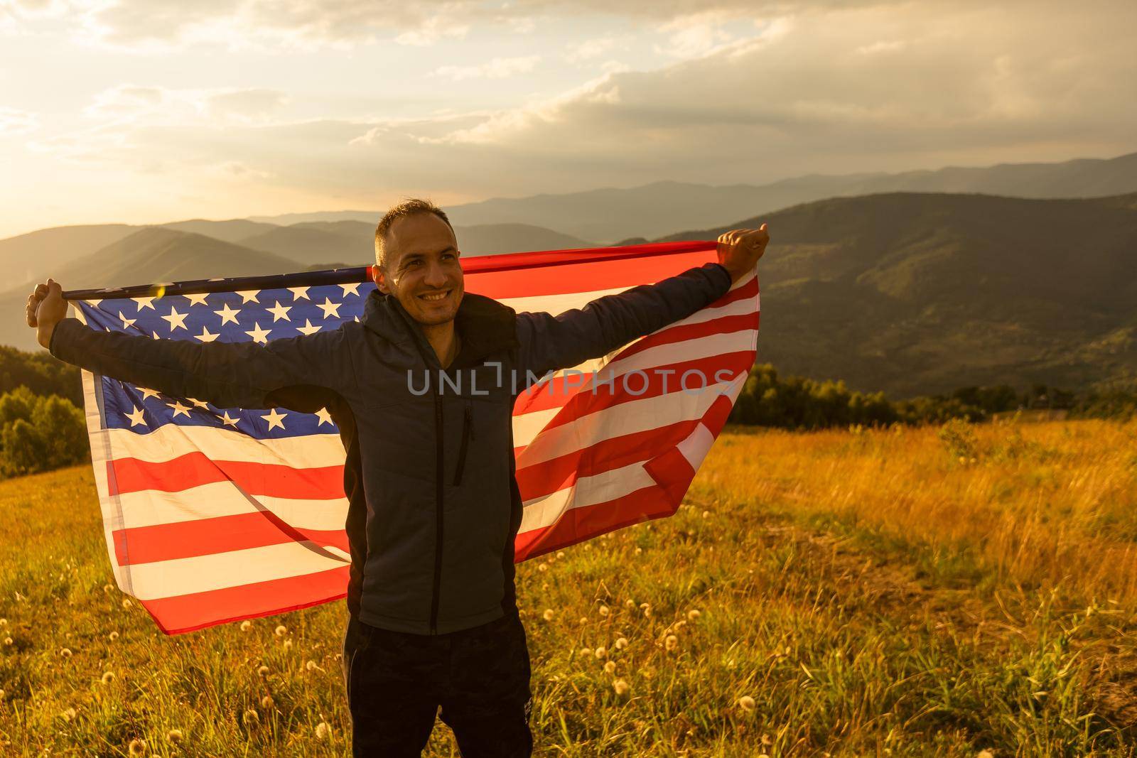 man holding an american flag.