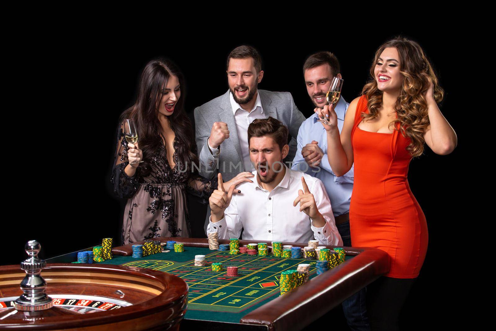 Group of young people looking excited at spinning roulette by nazarovsergey