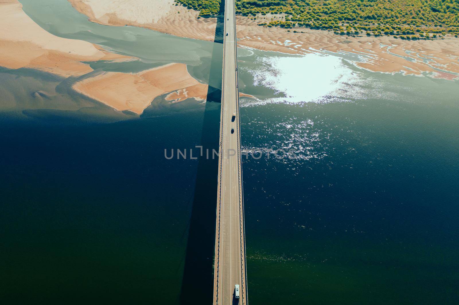 aerial car bridge over river with sandy dunes coast by fascinadora